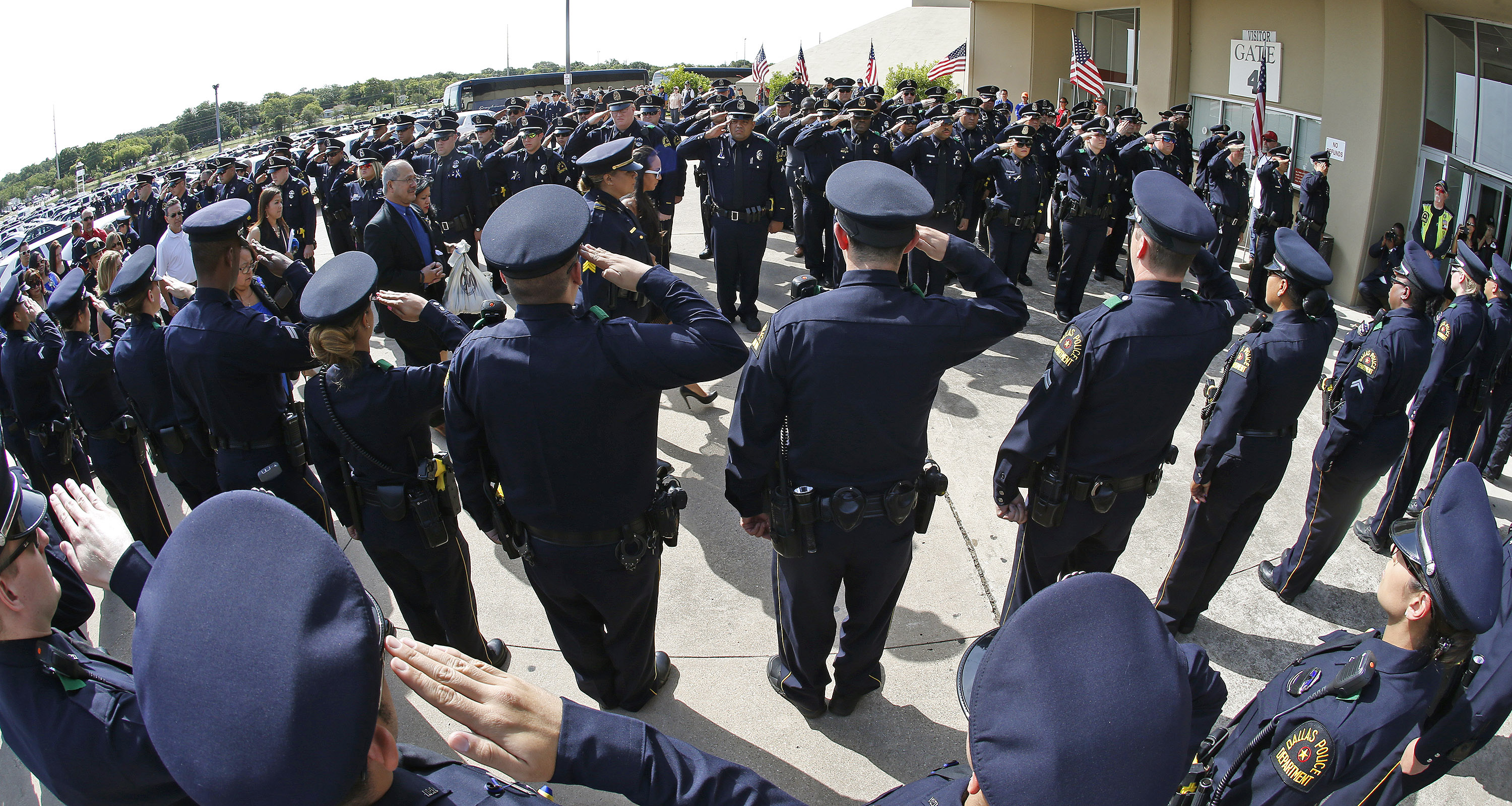 Dallas Police officers salute as family of officer Patrick Zamarippa arrives for his funeral on July 16, 2016. Zamarippa was one of the officers killed during the shooting in Dallas on July 7, 2016. Since, Texas Governor Greg Abbott has proposed that attacking police officers should be classified as a hate crime. (Paul Moseley—Fort Worth Star-Telegram/TNS/Getty Images)