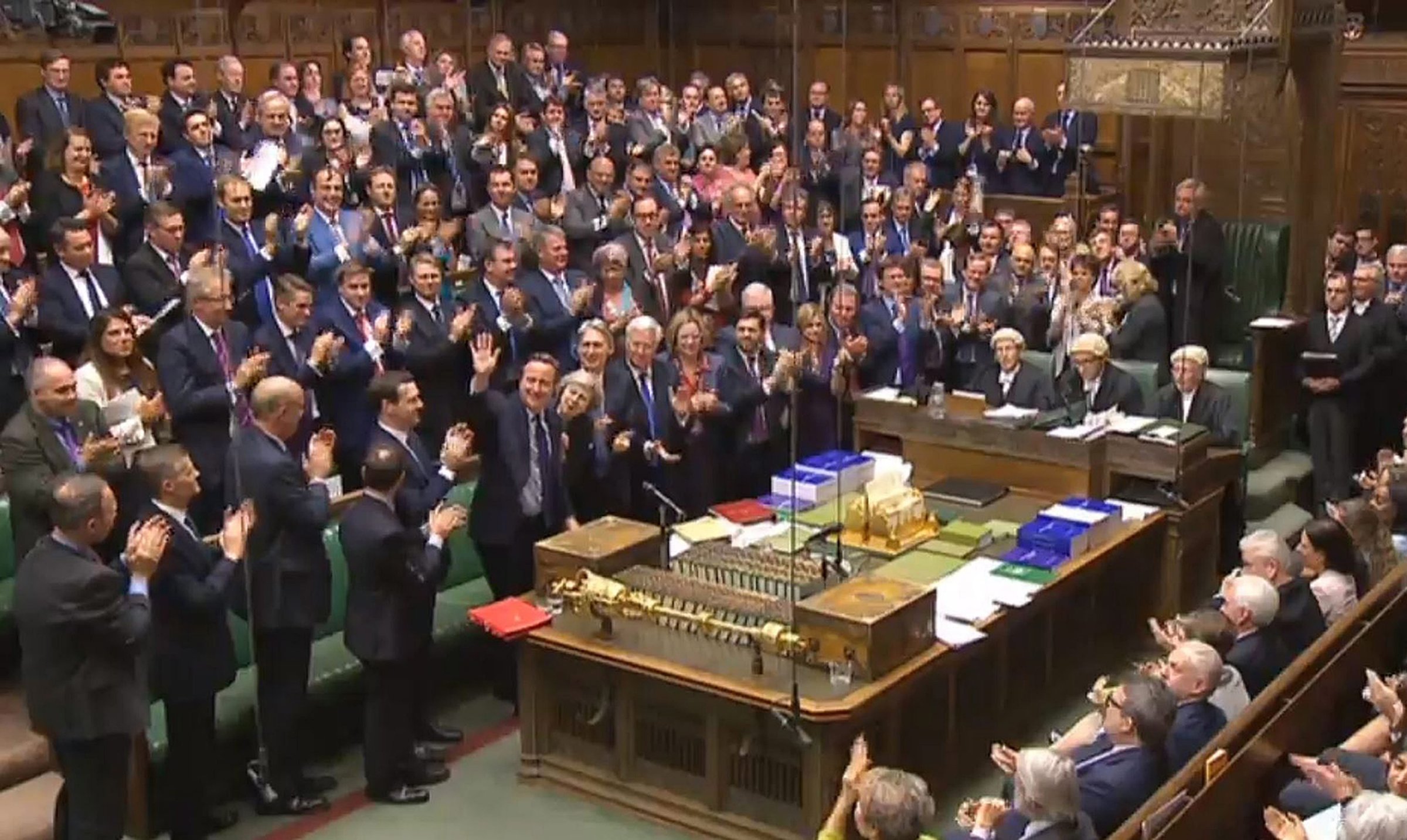A British Parliament handout photo released shows Conservative Members of Parliament giving outgoing Prime Minister David Cameron a standing ovation after finishing his last Prime Minister's Questions in the House of Commons, in London on July 13, 2016.