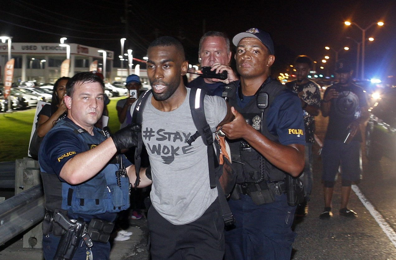 Police arrest activist DeRay McKesson during a protest along Airline Highway, a major road that passes in front of the Baton Rouge Police Department headquarters, July 9, 2016.