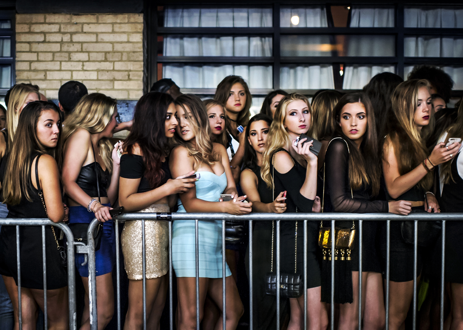 Young women stand in line waiting for access to a popular club in August 2015.