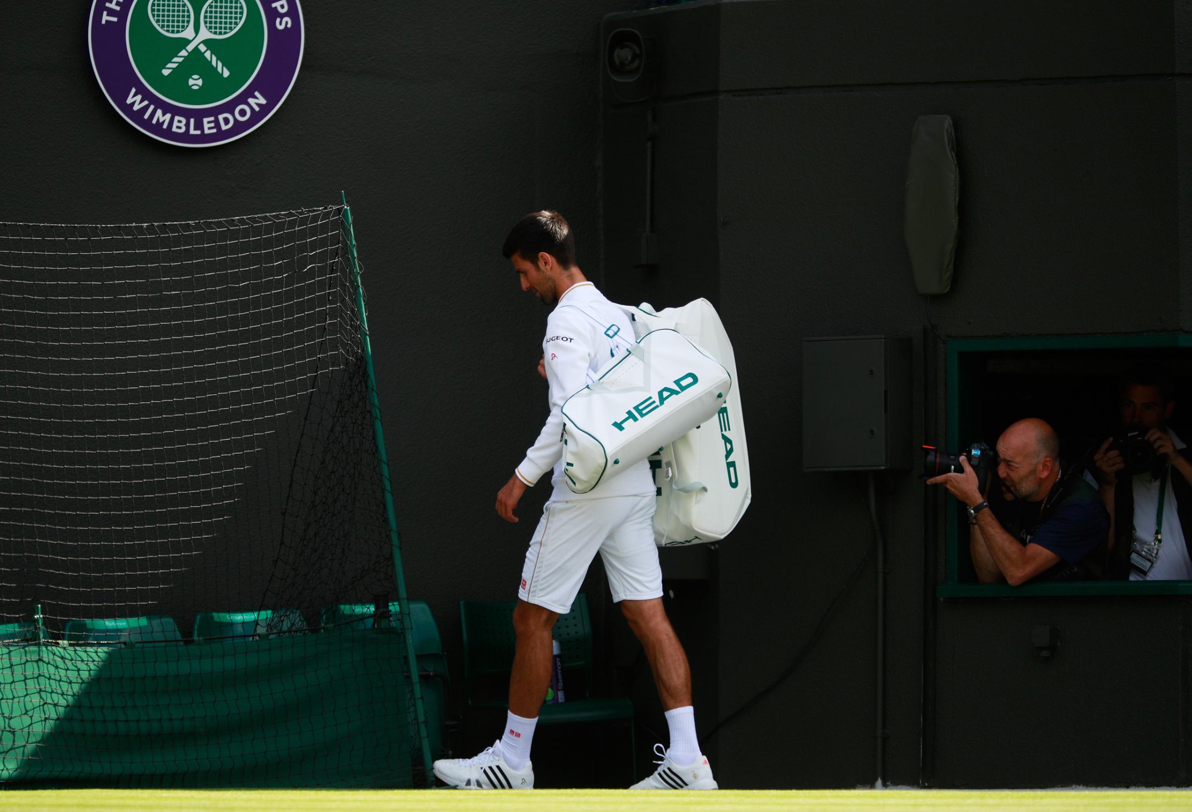 Novak Djokovic of Serbia walks off the court following defeat in the Men's Singles third round match against Sam Querrey of the United States on day six of the Wimbledon Lawn Tennis Championships in London on July 2, 2016.