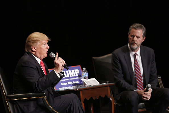 Donald Trump, president and chief executive of Trump Organization Inc. and 2016 Republican presidential candidate, left, speaks as Jerry Falwell Jr., president of Liberty University, listens during a campaign event at the Orpheum Theater in Sioux City, Iowa, U.S., on Sunday, Jan. 31, 2016.