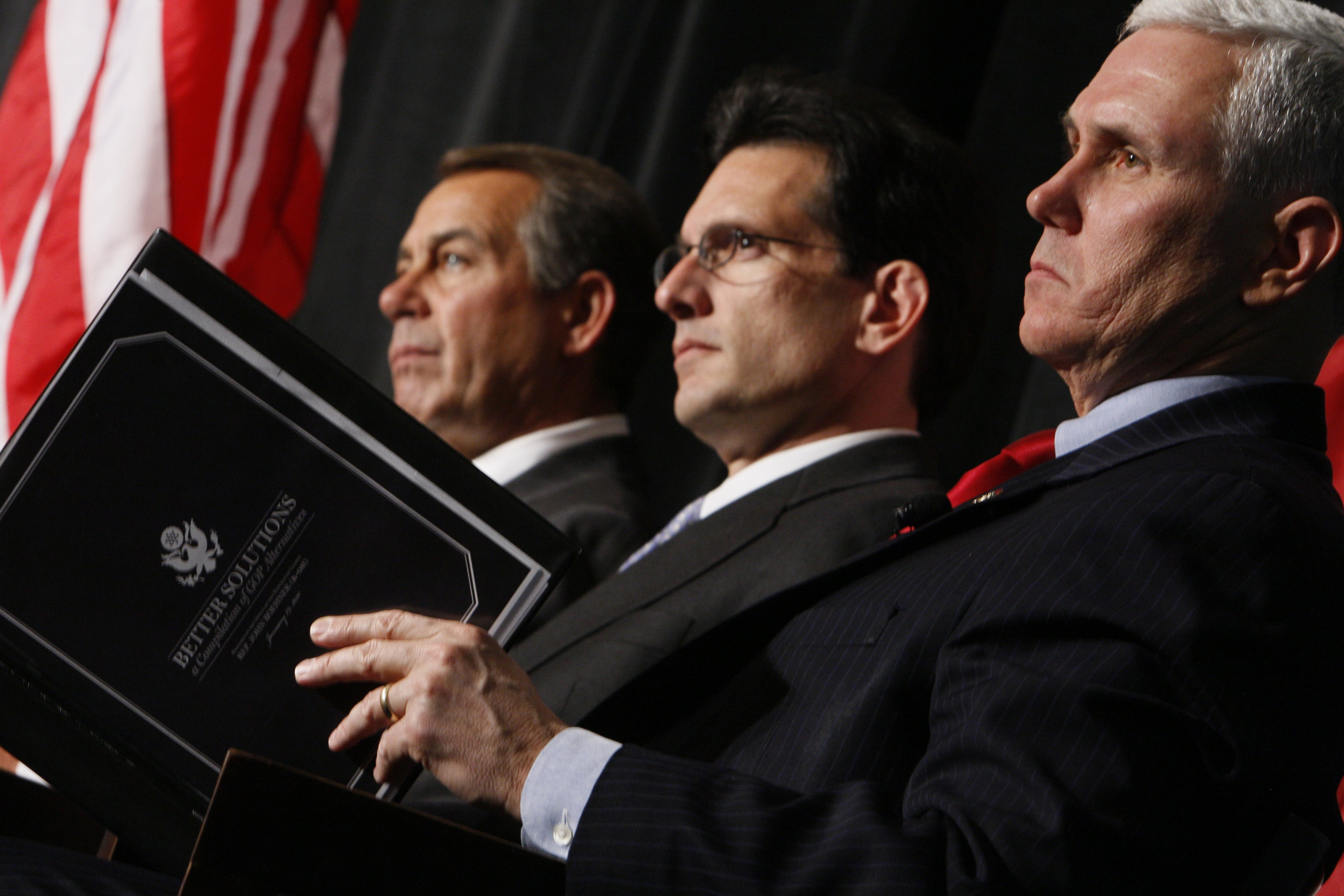 From left, House Minority Leader John Boehner of Ohio, House Minority Whip Eric Cantor of Va., and Rep. Mike Pence, R-Ind., listen as President Barack Obama speaks to Republican lawmakers at the GOP House Issues Conference in Baltimore on Jan. 29, 2010.