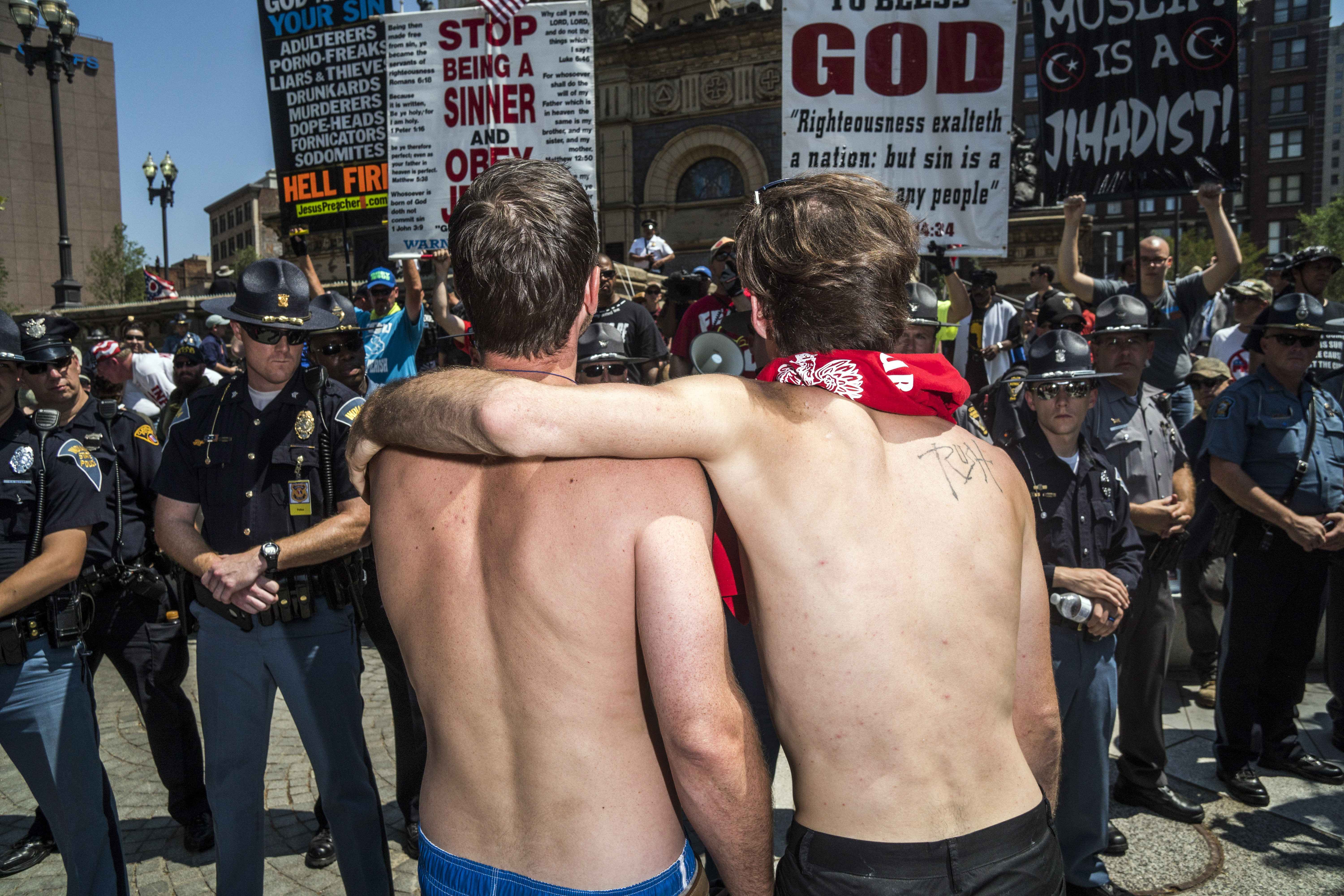 A pair of men interact with protesters in the Cleveland Public Square at the Republican National Convention in Cleveland on Tuesday, July 19, 2016.