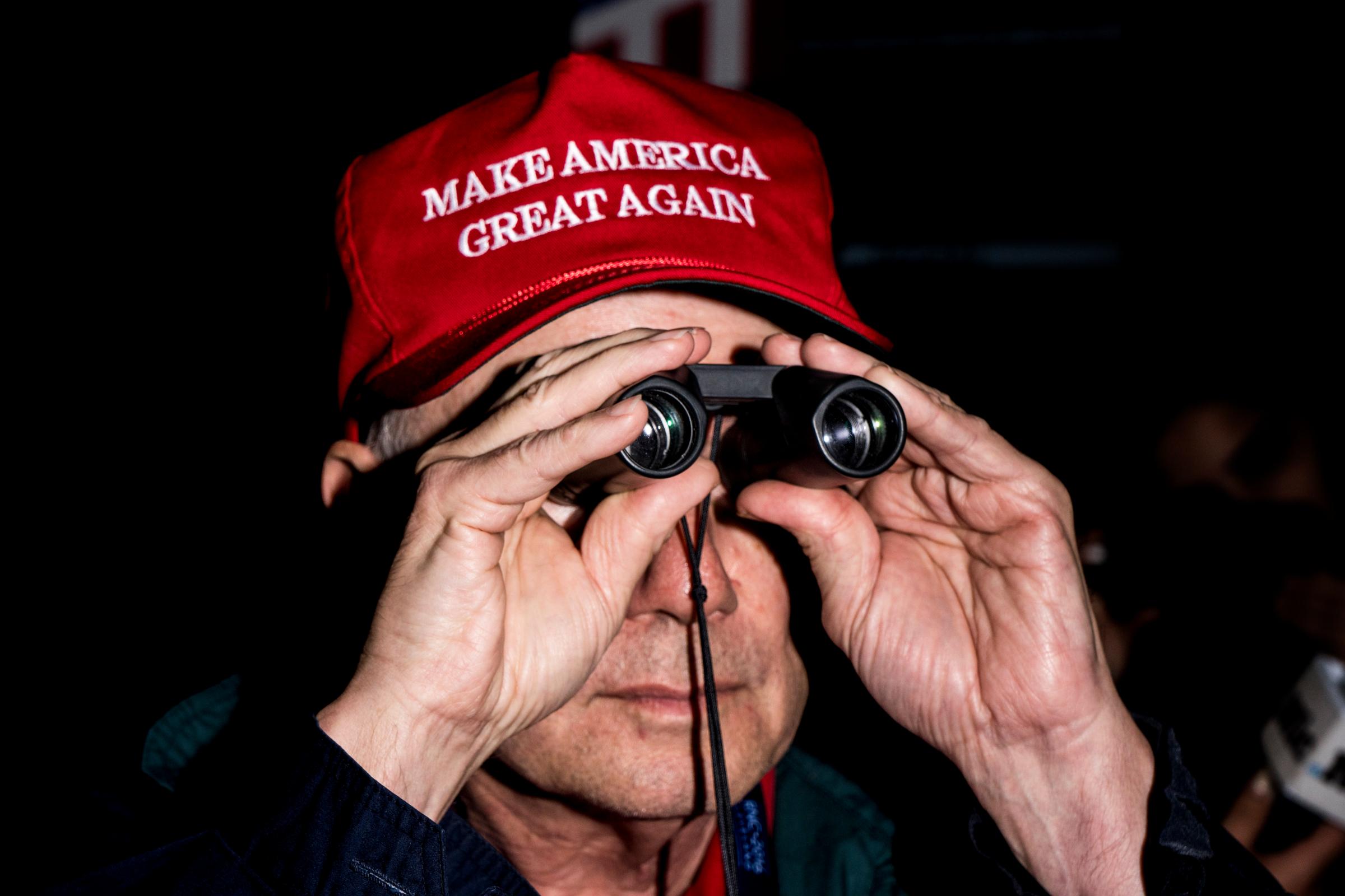 A man dons a "Make America Great Again" hat at the Republican National Convention in Cleveland.