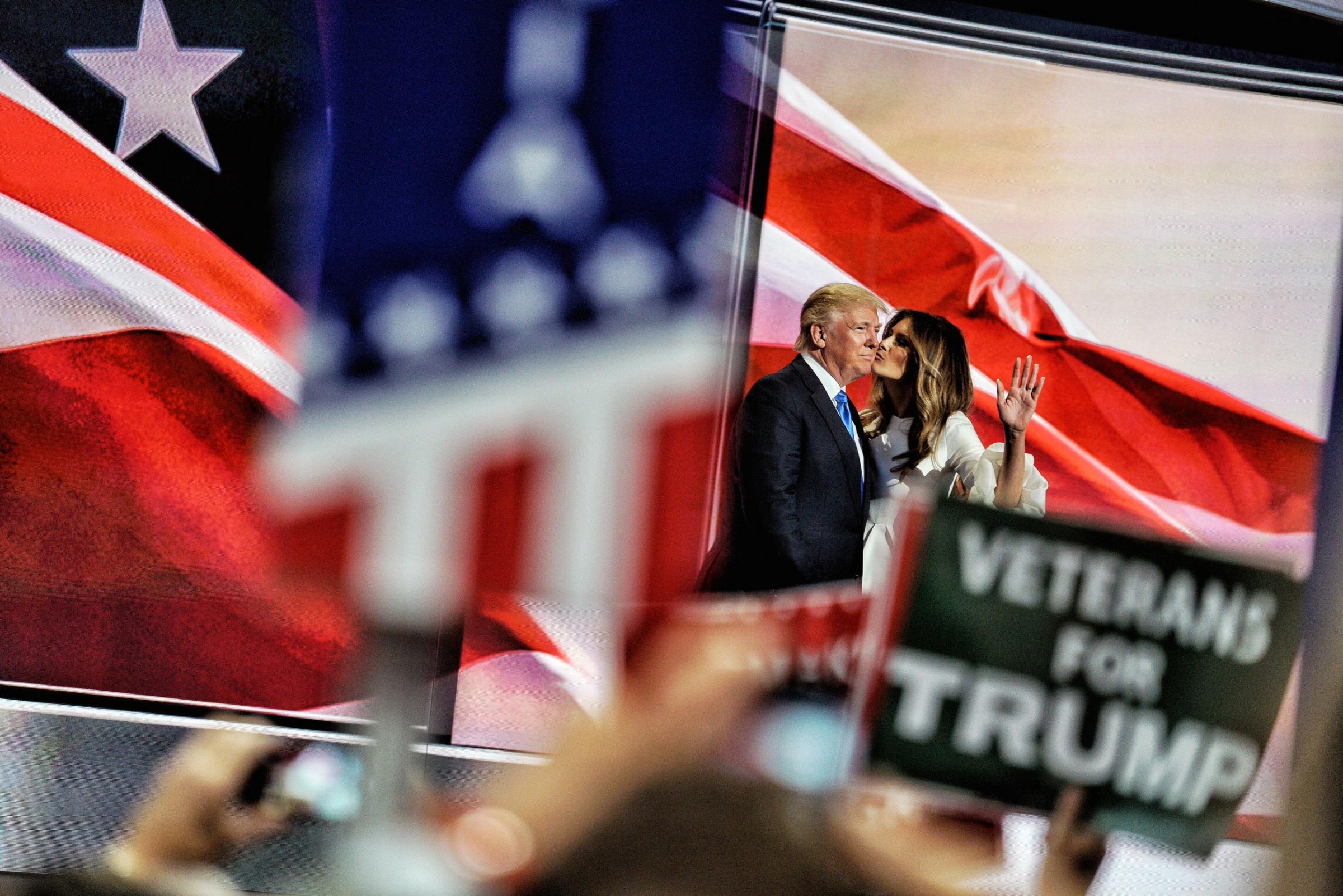 Melania Trump kisses her husband, Republican presidential candidate Donald Trump, to the applause of the ecstatic crowd, on July 18, 2016.