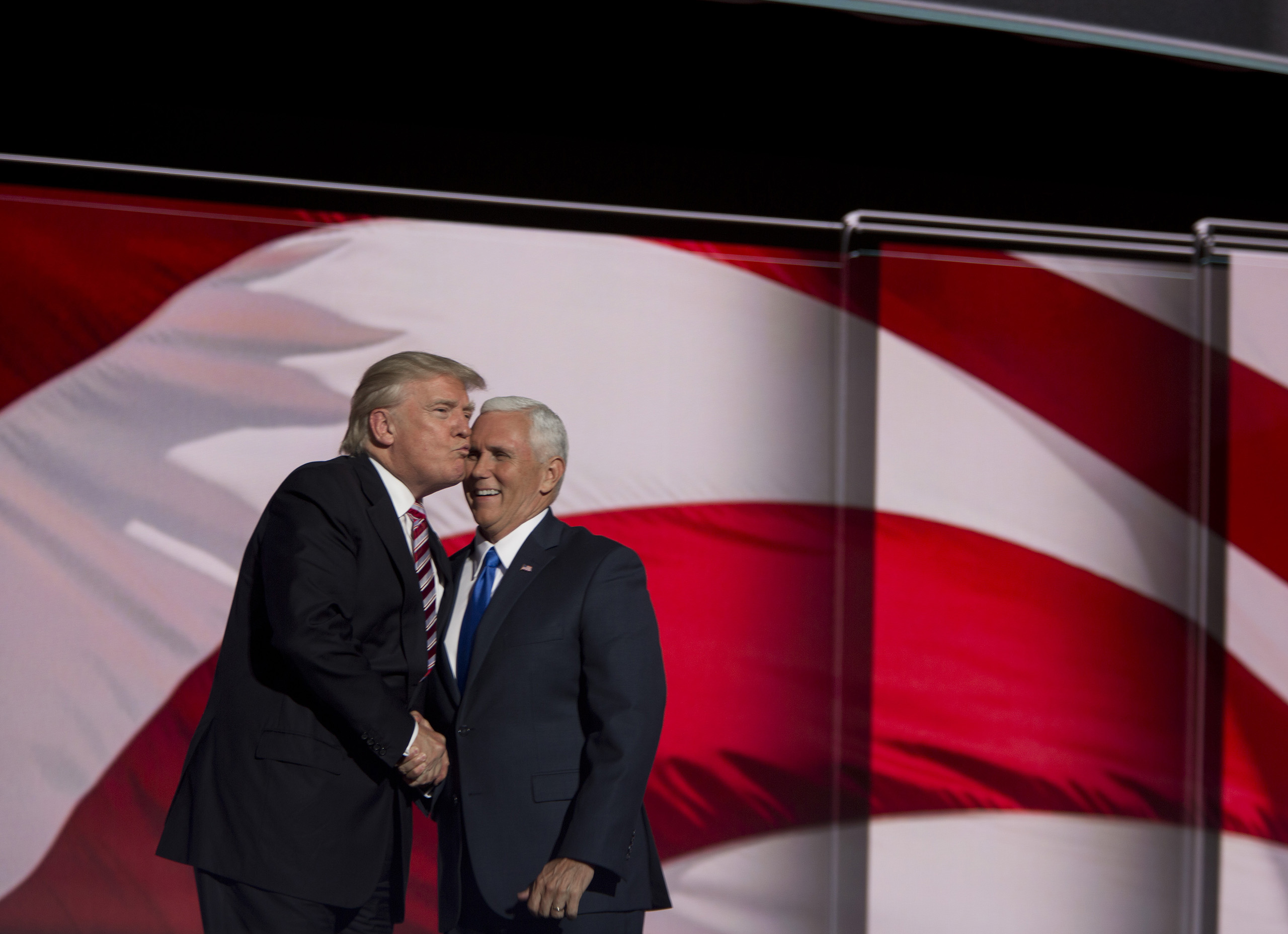 Republican presidential candidate Donald Trump congratulates Republican vice presidential candidate Mike Pence after he delivered a speech on the third day of the Republican National Convention on July 20, 2016 at the Quicken Loans Arena in Cleveland, Ohio.