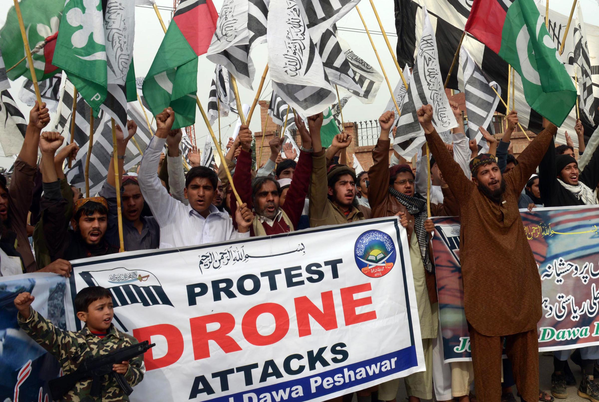 Supporters of Defense of Pakistan Council (DPC), a coalition of religious and political parties, protest against the US drone strikes in the Pakistani tribal region, in Peshawar on Nov. 10, 2013.