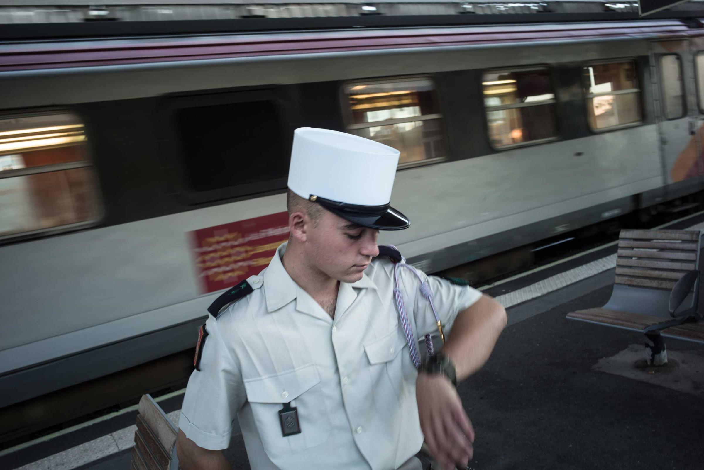 A young French Legionnaire is waiting for a train to go home near Marseille. Regulations forbid him from leaving Nimes, and the week after this photograph was taken, he was caught by an officer who was also waiting at the station. Nimes, France. Aug. 14, 2015.