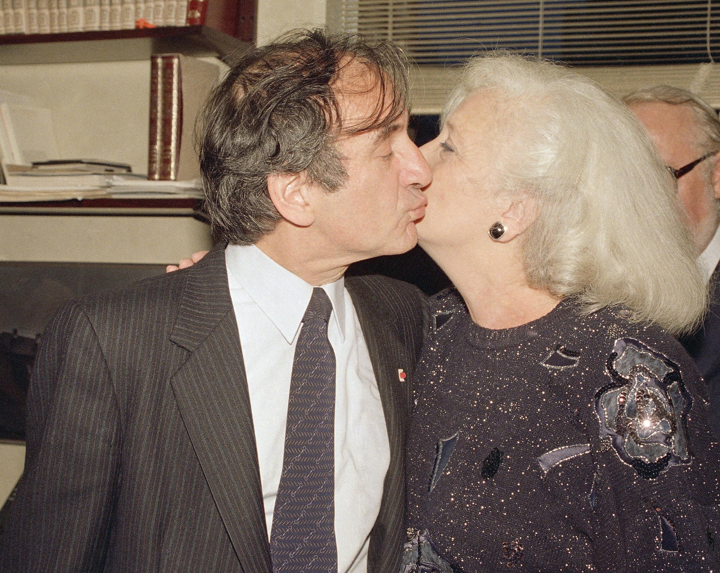 Holocaust survivor Elie Wiesel kisses his wife, Marion, as they greet the press after the Nobel announcement in their apartment in New York City on Oct. 14, 1986.