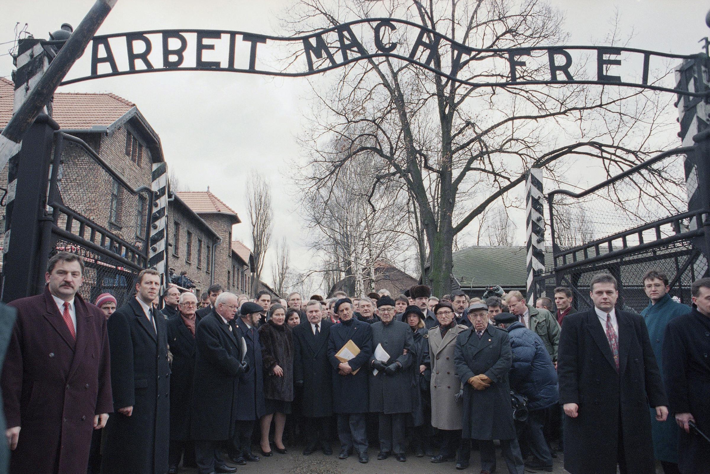Delegates stand at the main entrance of the Auschwitz concentration camp, after the official ceremony of the 50th anniversary of the camp's liberation by the Red Army, in Poland on Jan. 27, 1995.