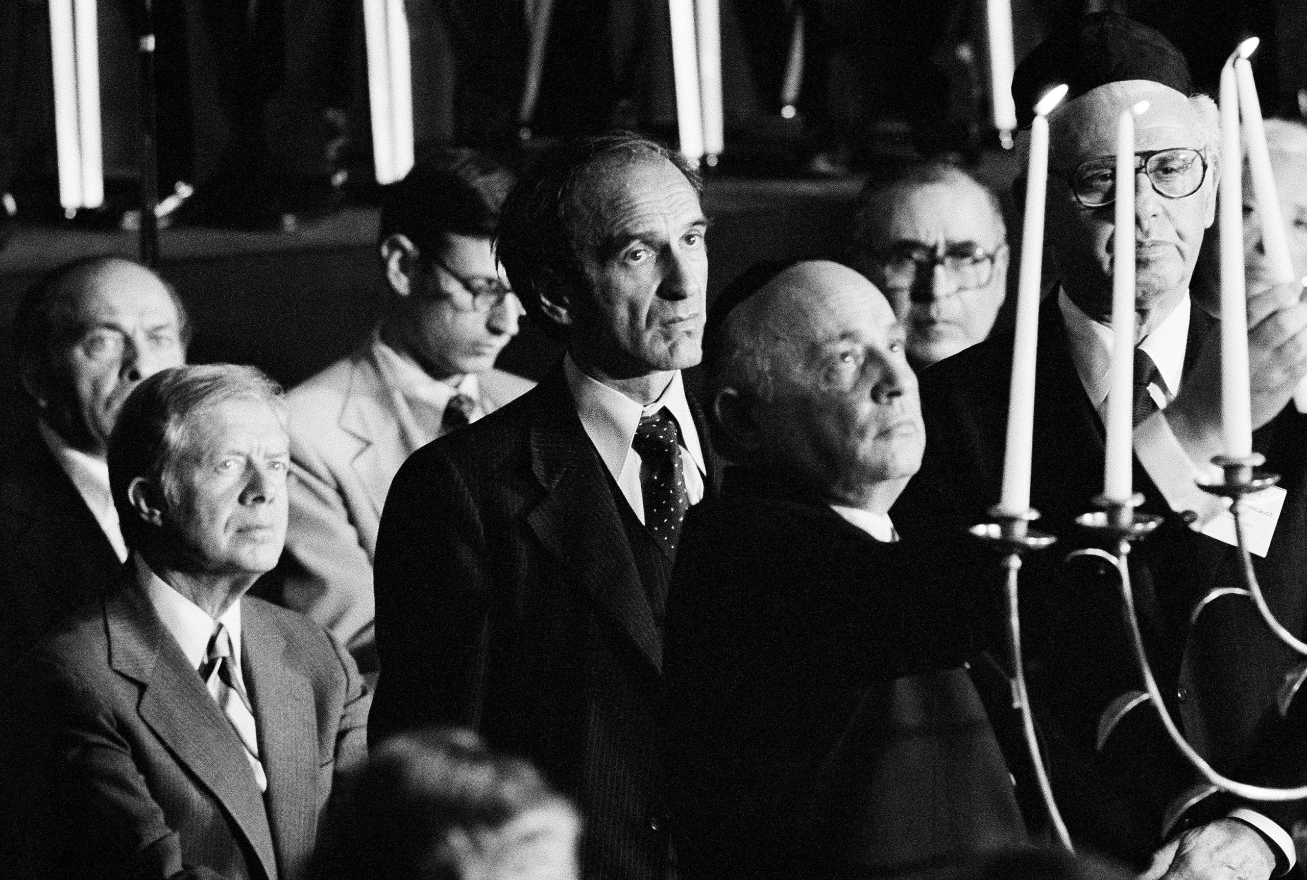 President Jimmy Carter left, and Elie Wiesel, chairman of the President's Commission on the Holocaust, watch as Cantor Isaac Goodfriend, and former Secretary of Labor Arthur Goldberg, right, light a menorah during a ceremony in remembrance of the victims of the Holocaust in Washington on April 24, 1979.