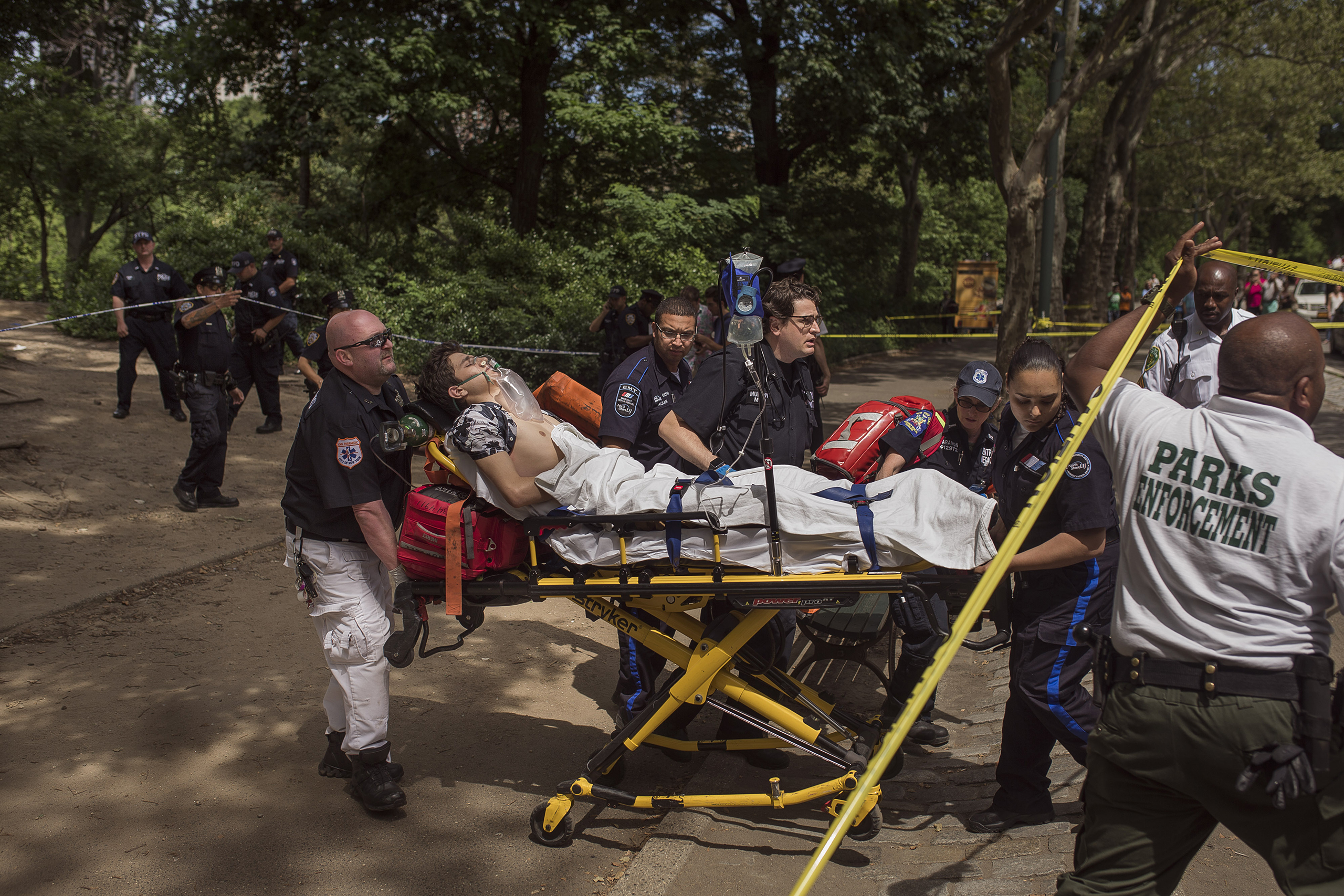 A injured man is carried to an ambulance in Central Park in New York City on July 3, 2016. (Andres Kudacki—AP)