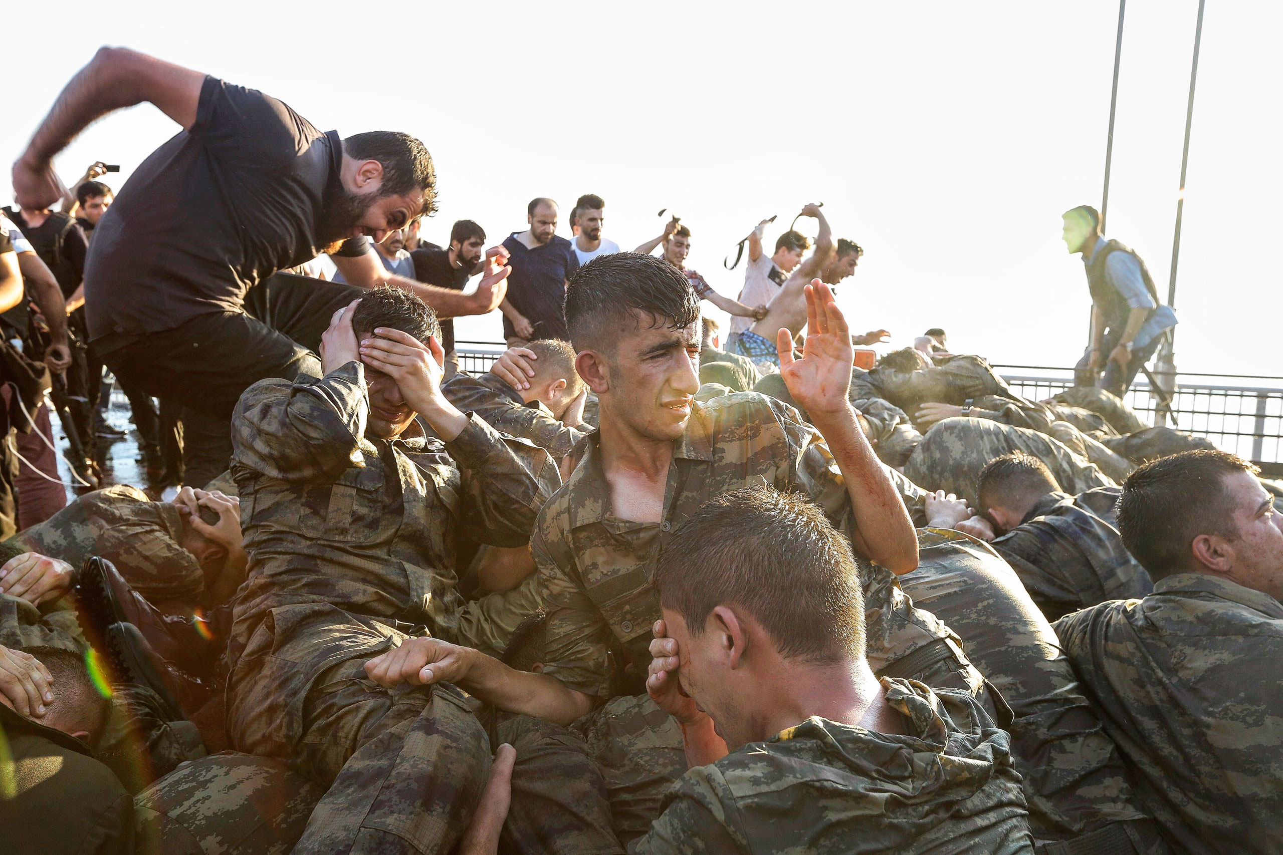 Soldiers involved in the attempted coup surrender on the Bosporus Bridge in Istanbul early on July 16; thousands of suspected plotters were later rounded up (Gokhan Tan—Getty Images)
