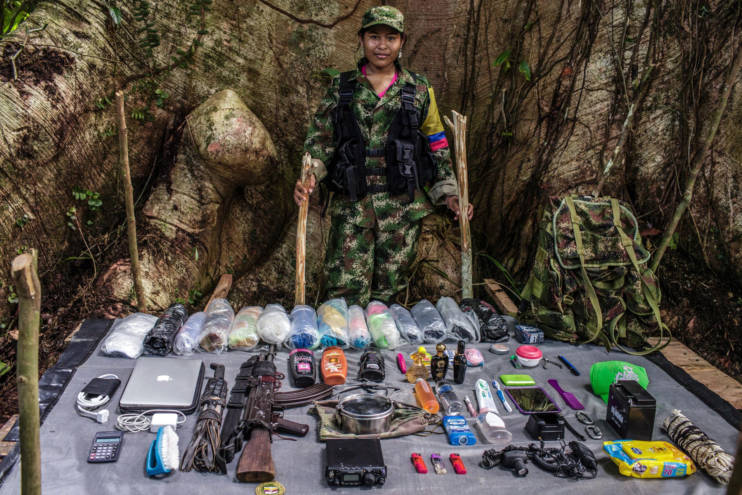 "Marcela", 18-years old, has been with FARC for two years. She is from an indigenous community that was attacked by a paramilitaries, and afterward she jointed FARC. As a radio operator, she carries a lot of gear for the group, including a laptop, radio, and batteries.