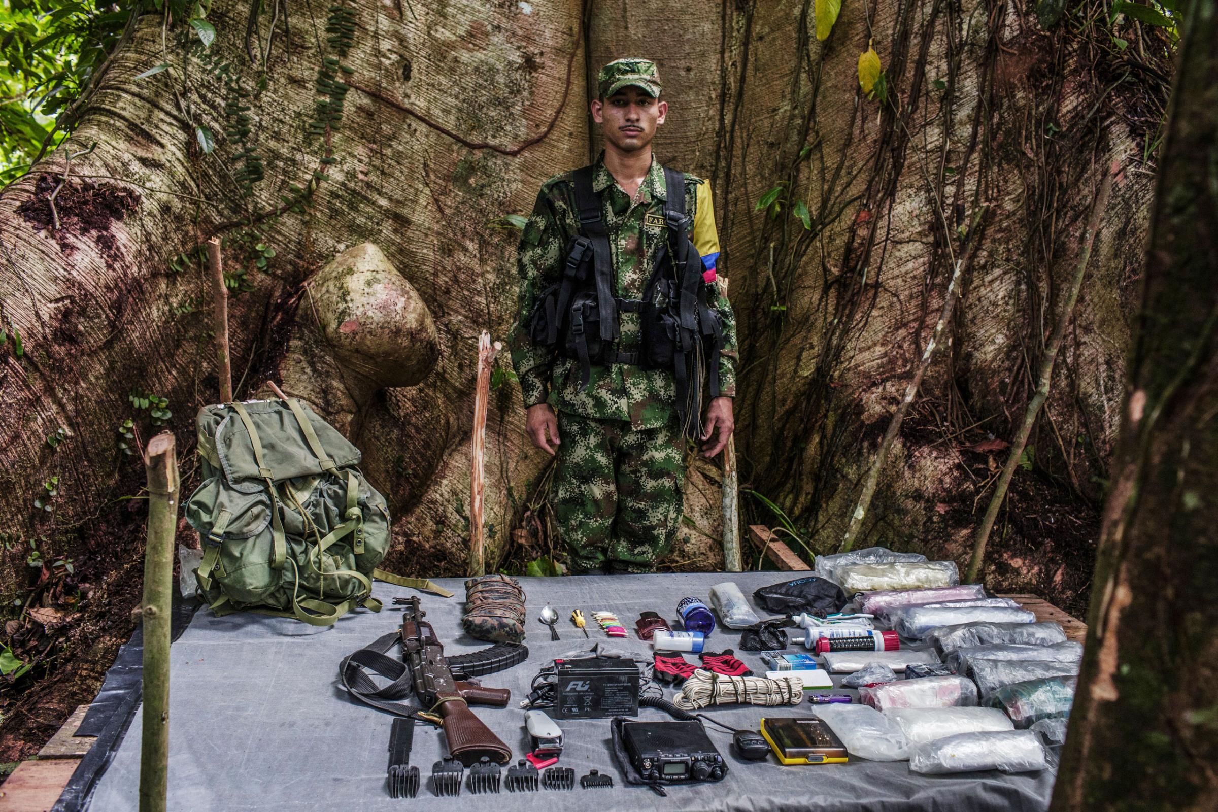 "Carlos," 19-years old is a radio operator and electrician with FARC. The radio requires a four pound battery which he carries, along with tools to repair machinery.