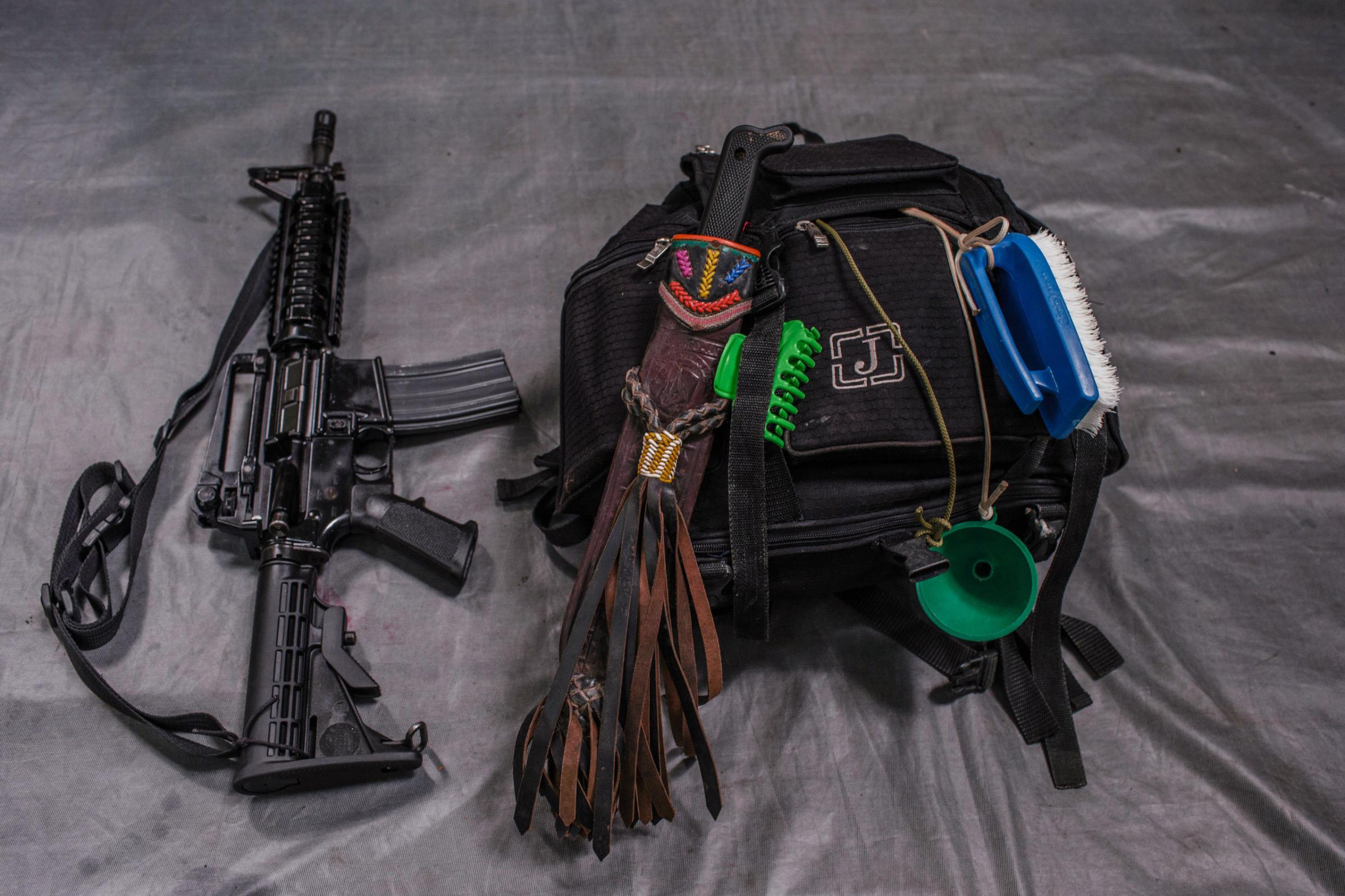 The backpack and M15 rifle that belong to "Glodis", a 33-year old who has been a FARC member for 19 years. She uses the  brush attached to her bag to wash clothes.