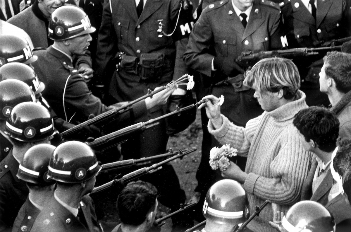 Antiwar demonstrators tried flower power on MPs blocking the Pentagon Building in Arlington, Va., on Oct. 26, 1967. (Bernie Boston—The Washington Post / Getty Images)