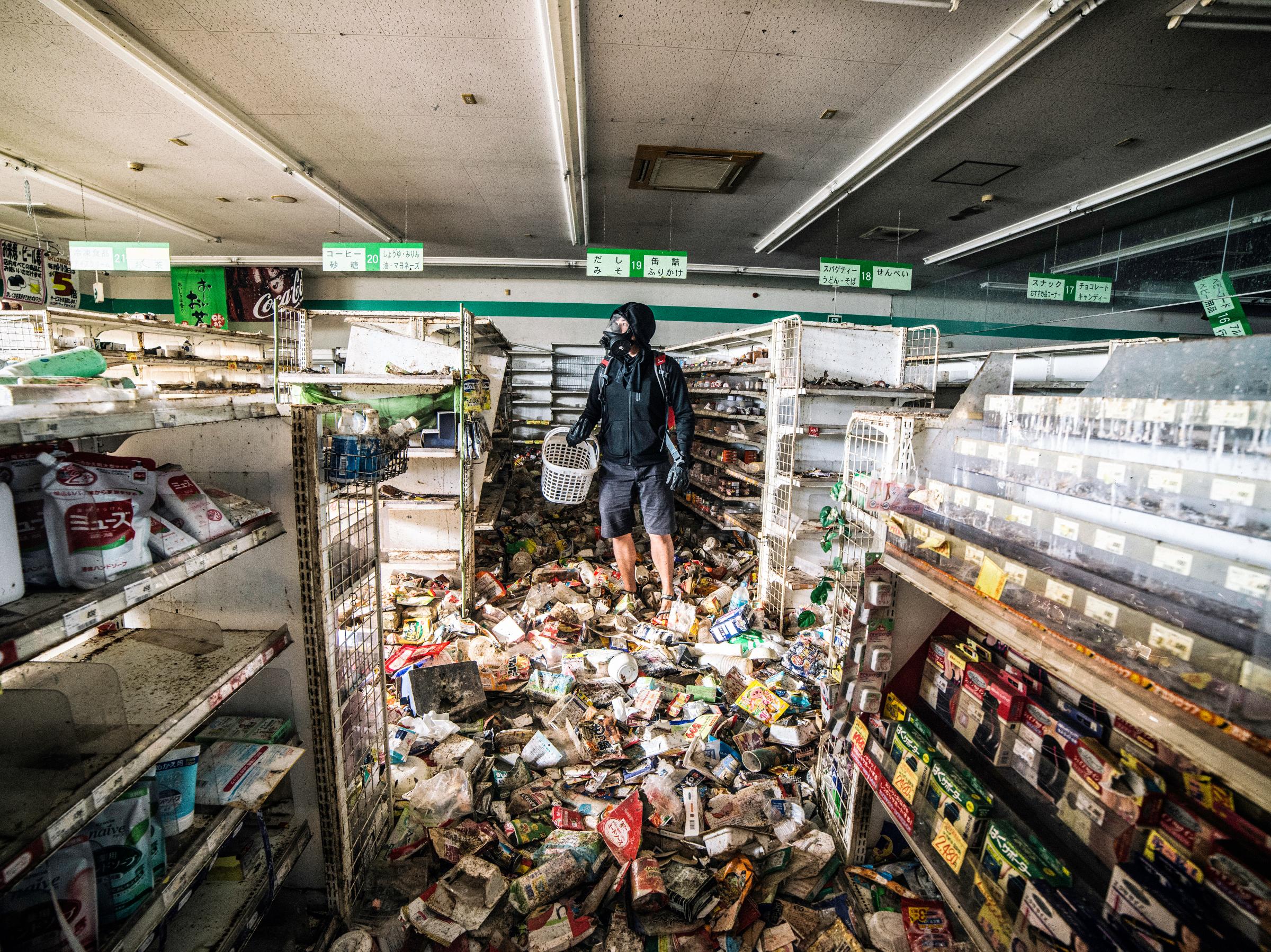 Malaysian photographer Keow Wee Loong ventured — ghostlike, if you will — into the Fukushima Exclusion Zone, within the twelve-mile radius around the old power plant, in June. The photographer "shops" in the super market York Benimaru on June 4, 2016.