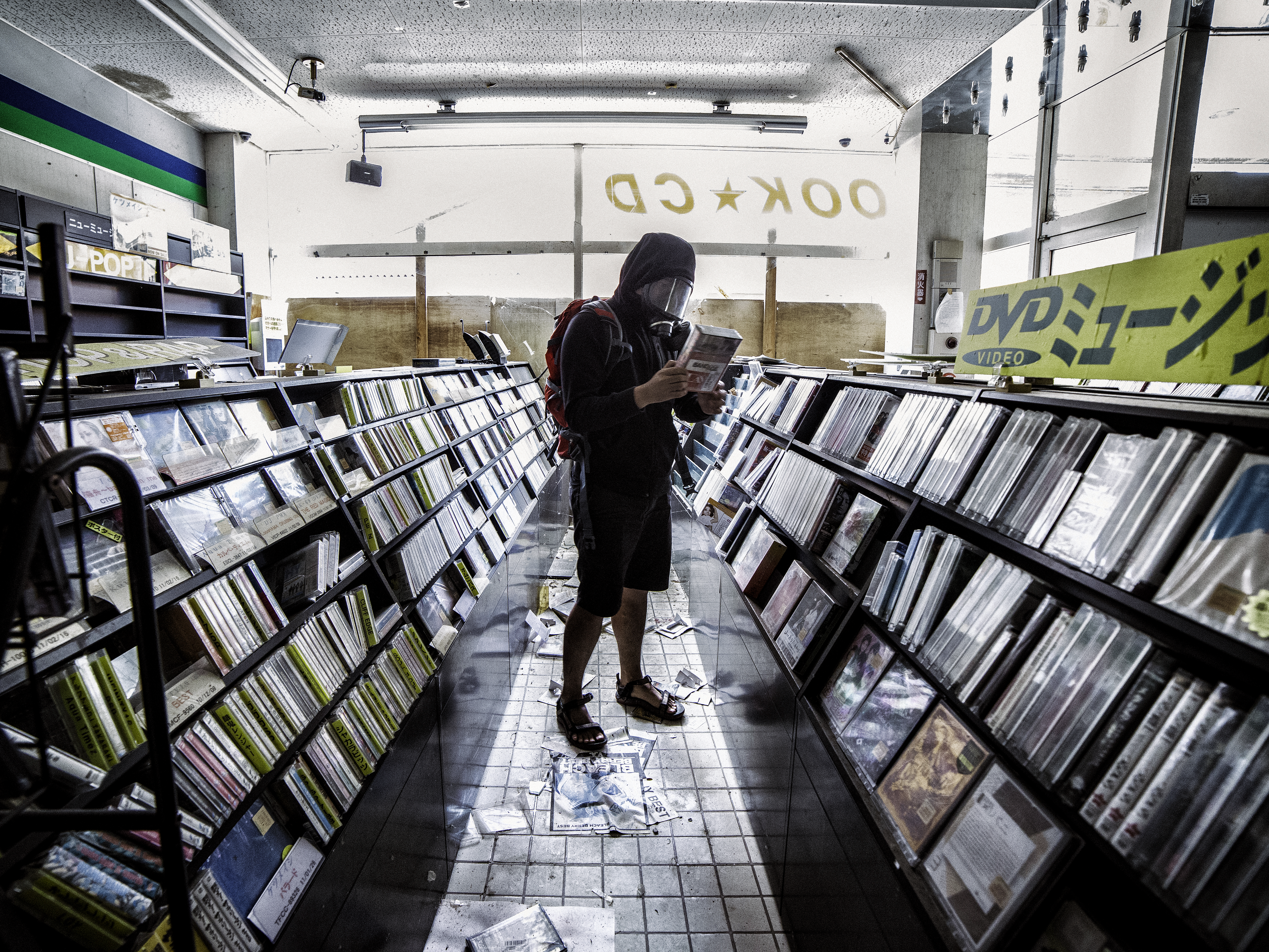 Keow Wee Loong browses CDs at a shop in Namie.