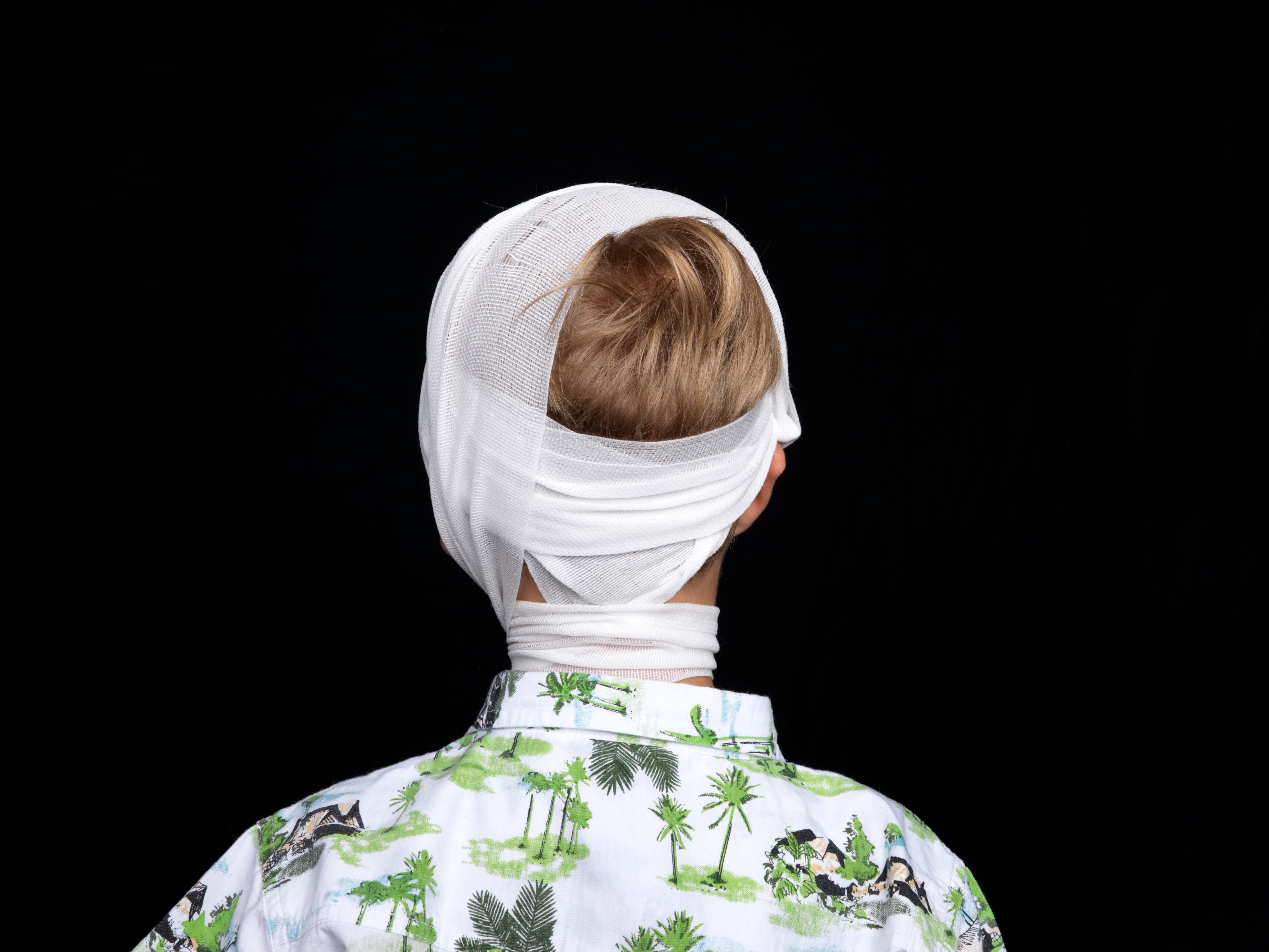 Young boy in head bandage