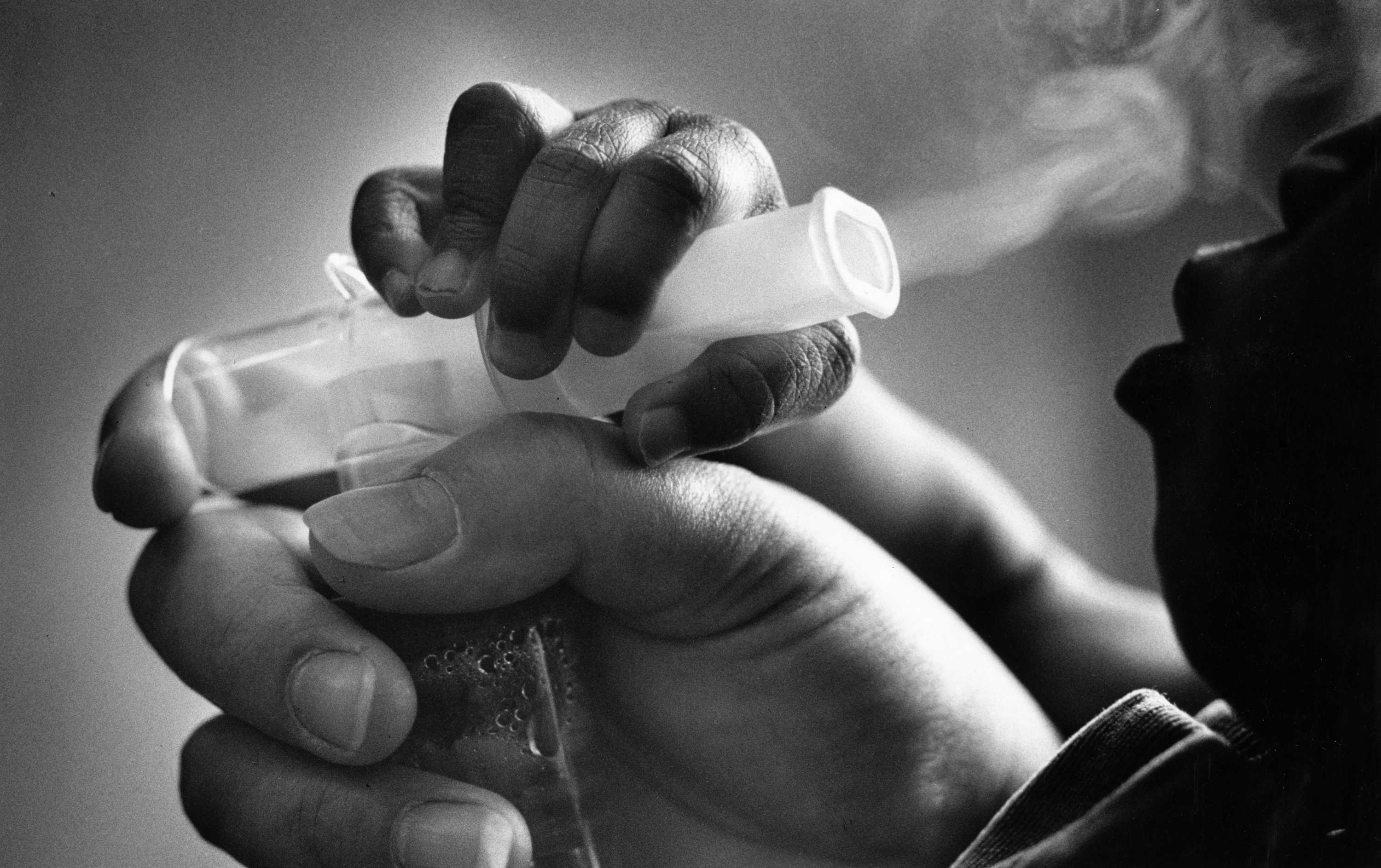 A foster child has an inhaler directed to his mouth so that he can ingest a medicated mist. The boy's mother used crack cocaine during her pregnancy. This photo ran in a <i>Boston Globe</i> story titled "Crack's Costly Legacy on Babies" in 1990. (Boston Globe&mdash;Boston Globe via Getty Images)