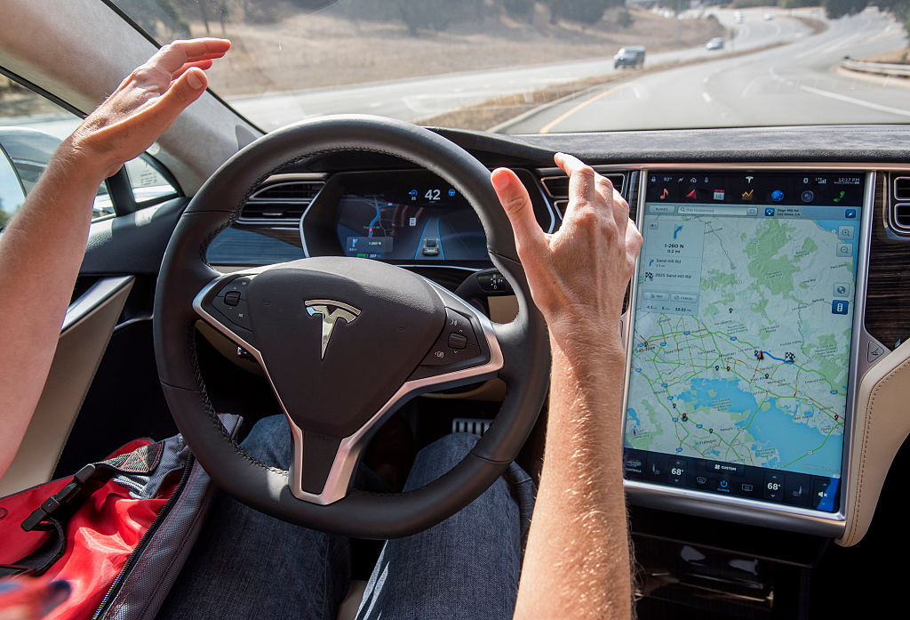 A member of the media test drives a Tesla Motors Inc. Model S car equipped with Autopilot in Palo Alto, California, U.S., on Wednesday, Oct. 14, 2015. (Bloomberg&mdash;Bloomberg via Getty Images)