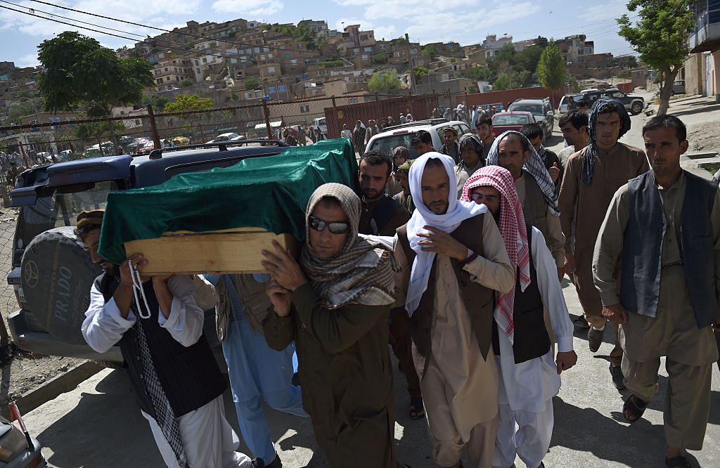 Relatives carry the coffin of Afghan police cadet Mohinddin ahead of his funeral prayers at The Qul Ab Chakan cemetery in Kabul on July 1, 2016, after his death in a Taliban attack in the Afghan capital.