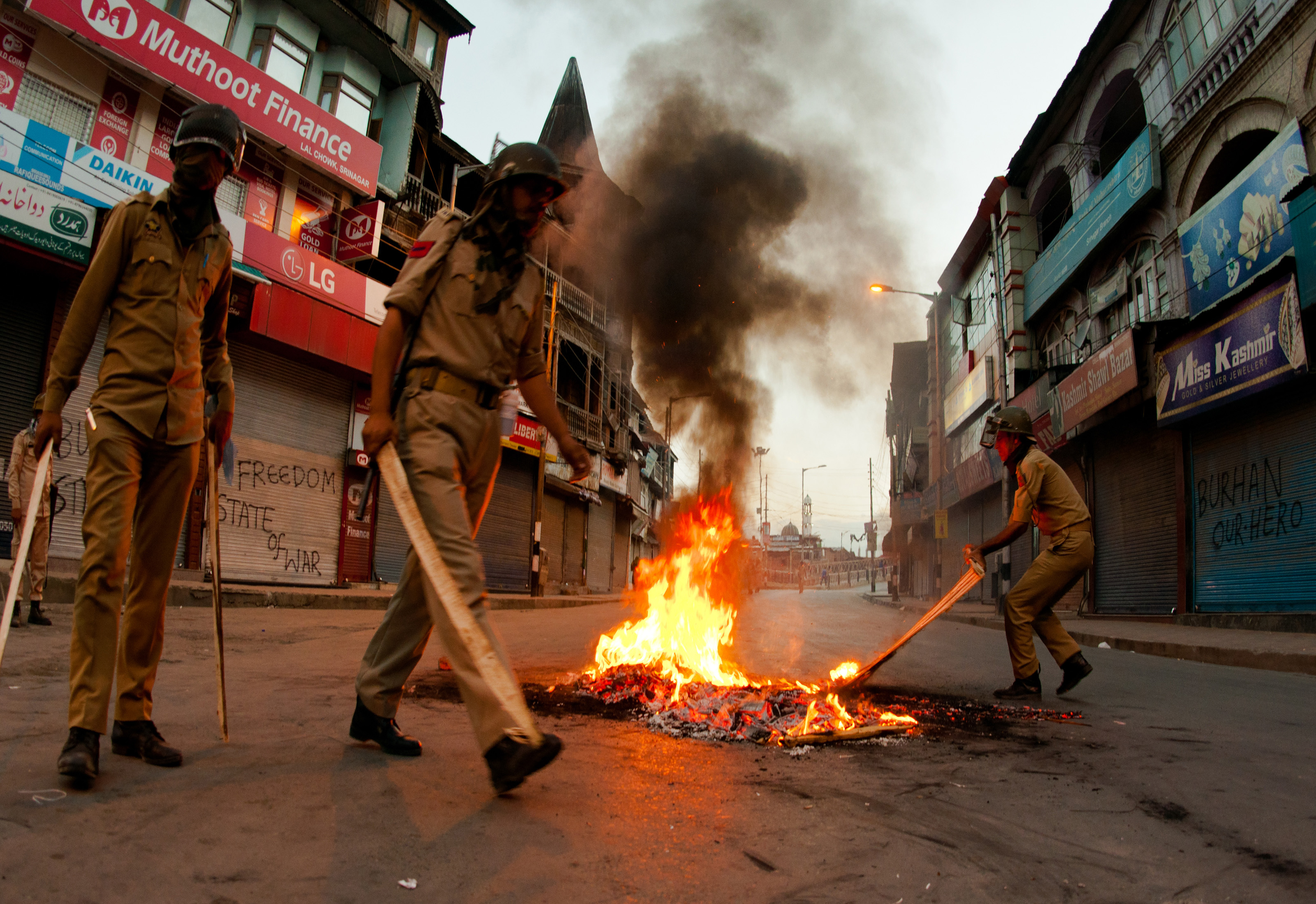 Indian government forces douse a burning tire left by the protesters during a curfew on July 10, 2016, in Srinagar, in the Indian-administered Kashmir, after 21 people were killed and more than 400 injured (Yawar Nazir—Getty Images)