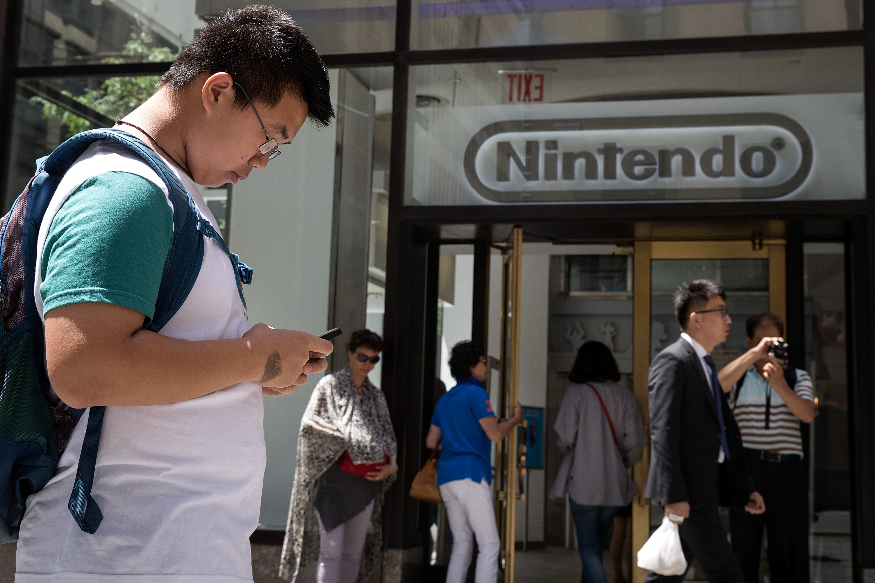 Tim (last name not given) plays Pokemon Go on his smartphone outside of Nintendo's flagship store, July 11, 2016, in New York City. The success of Nintendo's new smartphone game, Pokemon Go, has sent shares of Nintendo soaring (Drew Angerer—Getty Images)