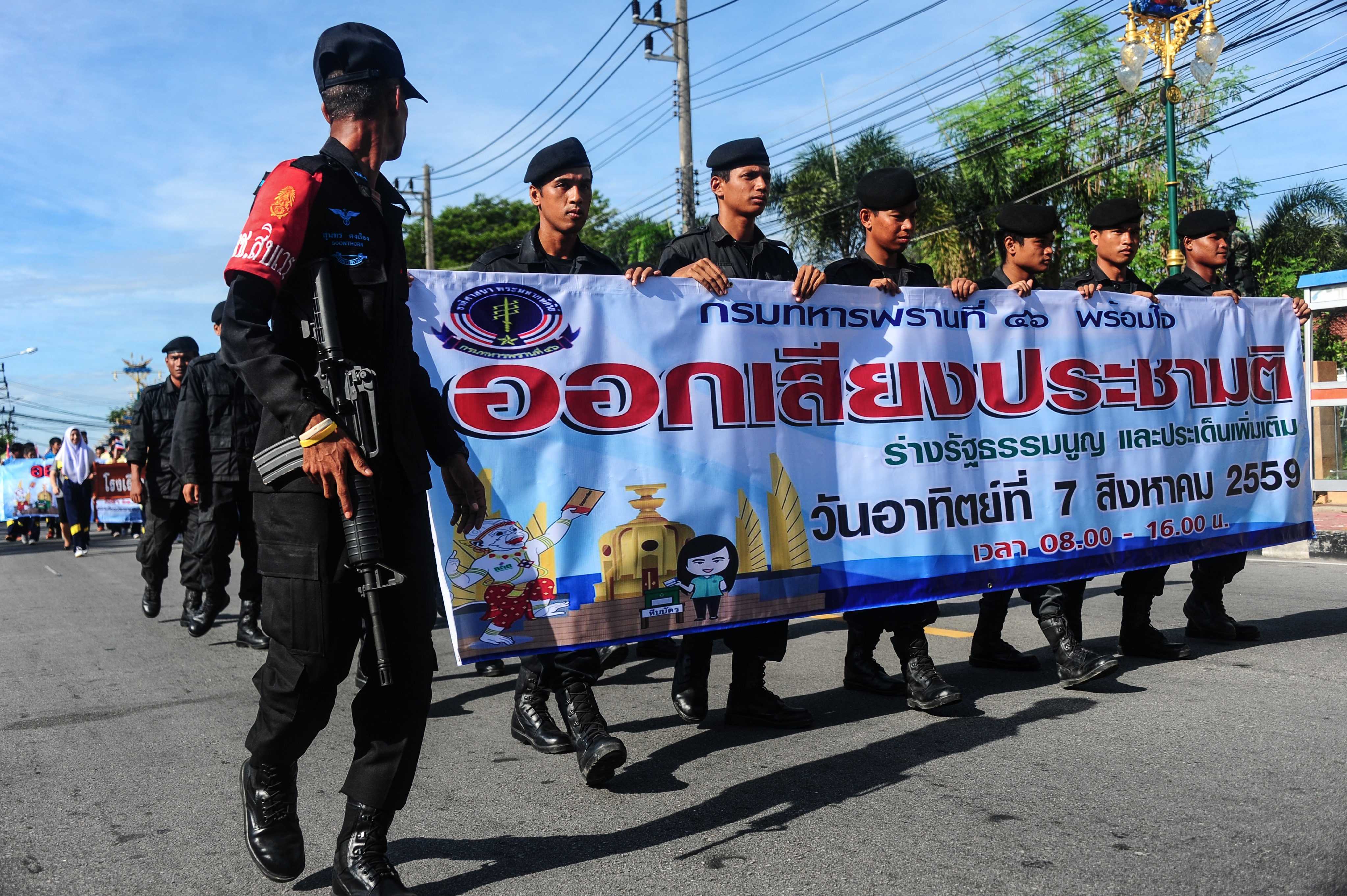 Soldiers hold banners as they march during a campaign encouraging the public to vote in the upcoming referendum on Thailand's draft constitution in Narathiwat province on July 22, 2016. (Madaree Tohlala—AFP/Getty Images)