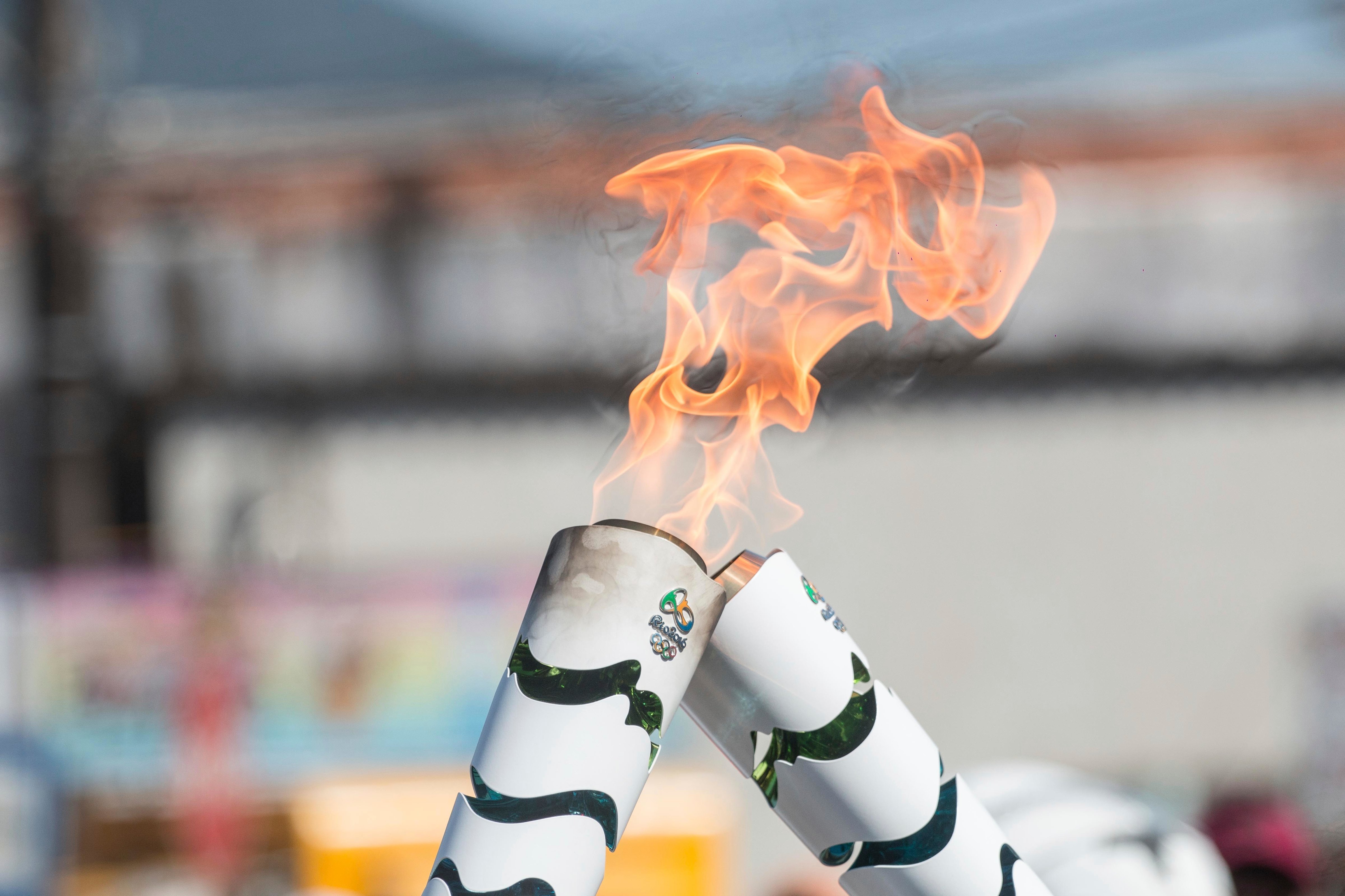 The Olympic torch and flames during Official Torch Relay on July 23, 2016 in Ubatuba, , Brazil. (Ale Meirelles—Brazil Photo Press/LatinContent/Getty Images)