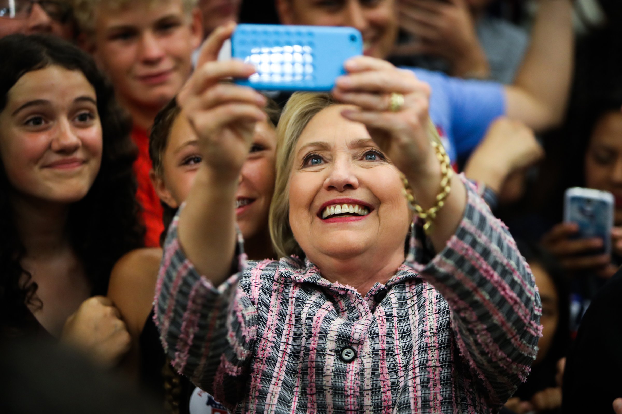 Hillary Clinton takes photographs with supporters after a campaign rally at Sacramento City College in Calif. on June 5, 2016.