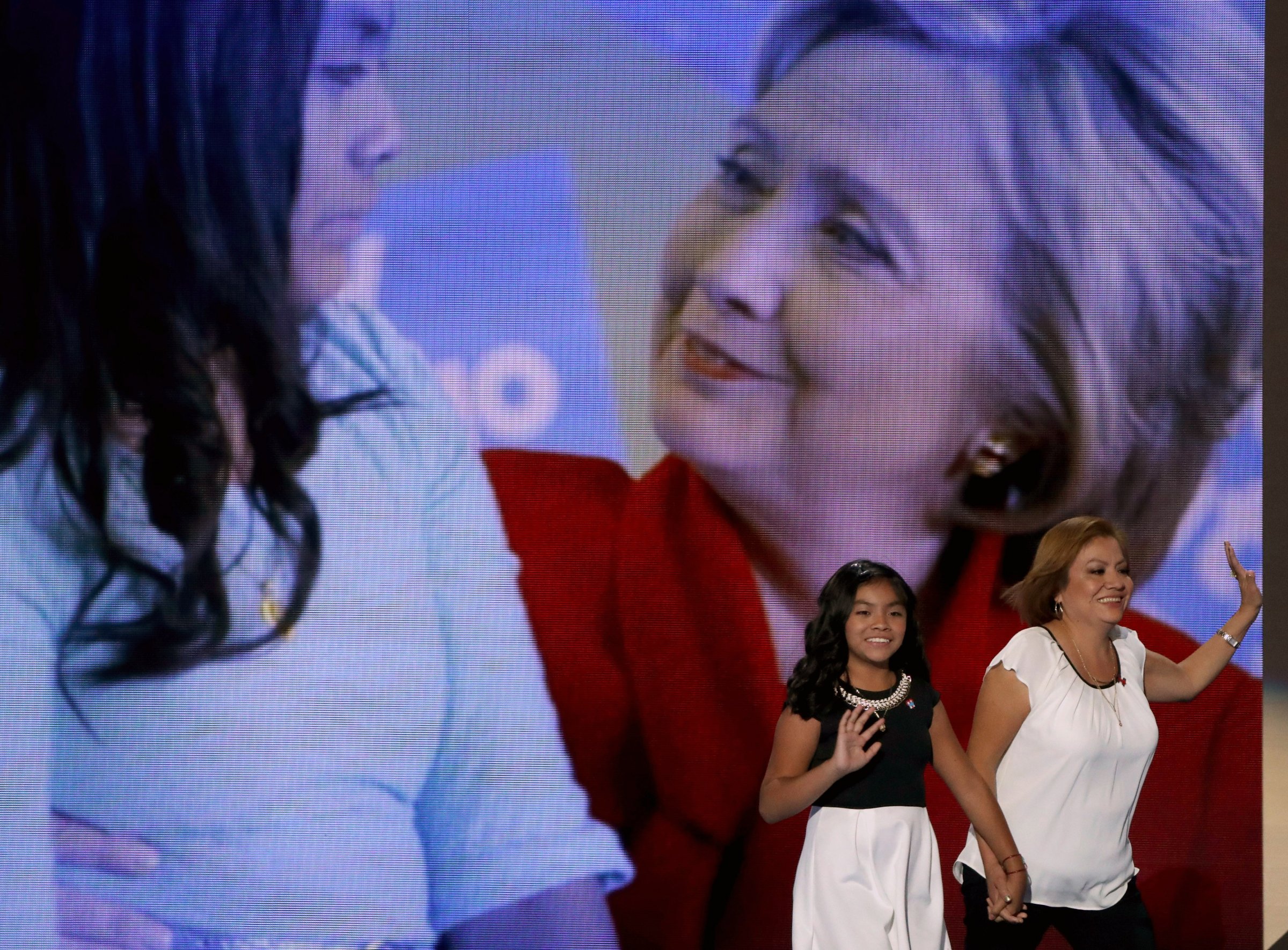 Karla Ortiz, 11, and her mother, Francisca Ortiz, walk out on stage to deliver remarks on the first day of the Democratic National Convention at the Wells Fargo Center, July 25, 2016 in Philadelphia.