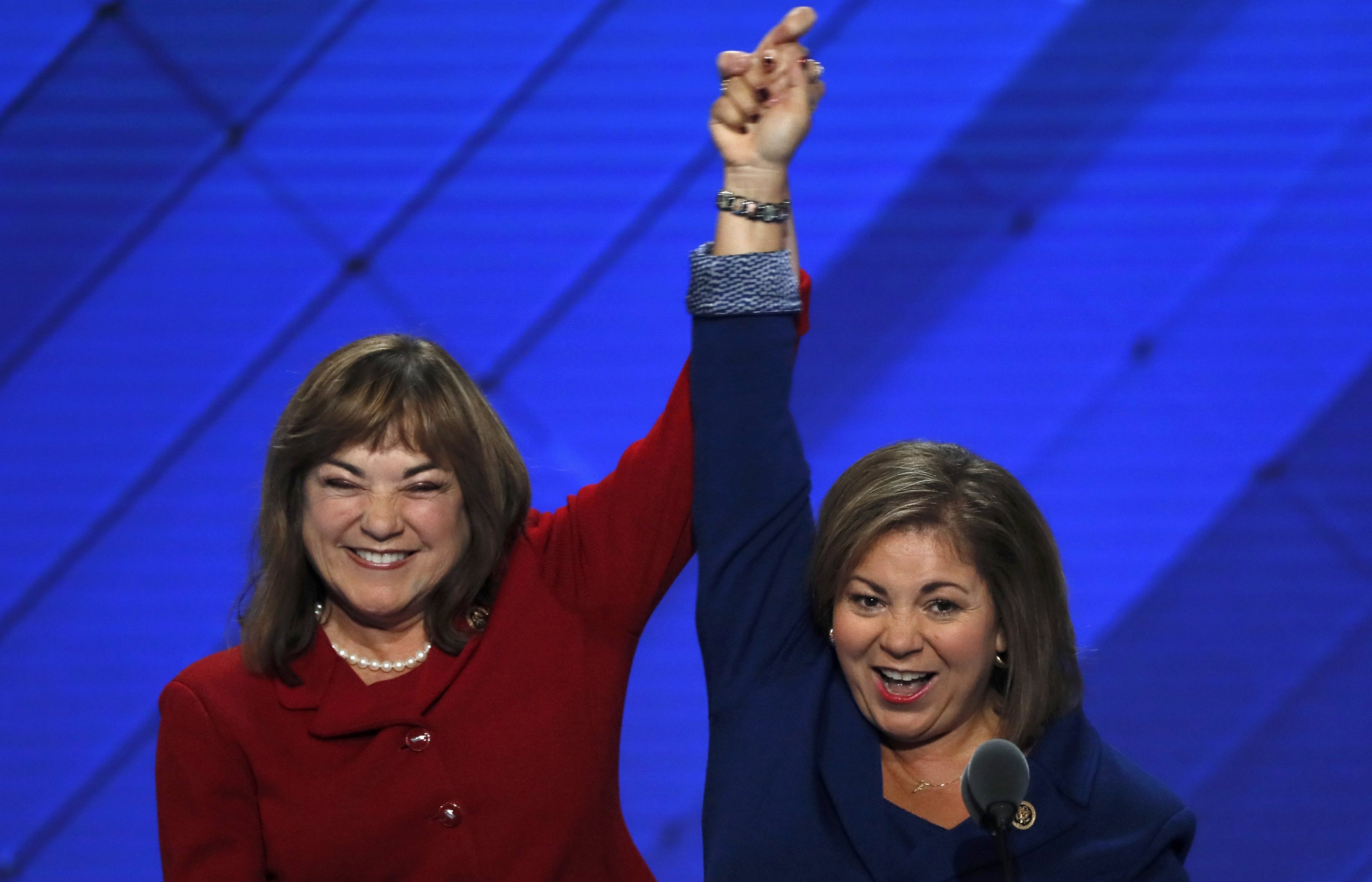 U.S. Rep. Linda Sanchez (D-CA) (R) and her sister and fellow Rep. Loretta join hands onstage at the Democratic National Convention in Philadelphia on July 25, 2016. (Mike Segar—Reuters)