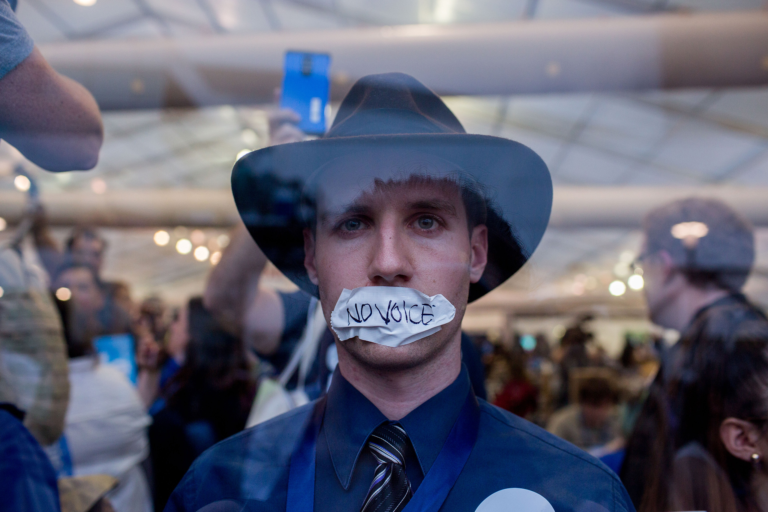 A supporter of Senator Bernie Sanders, holds a sign against the Trans-Pacific Partnership (TPP) while demonstrating inside the media tent during the Democratic National Convention on Tuesday, July 26, 2016 in Philadelphia, Pennsylvania.