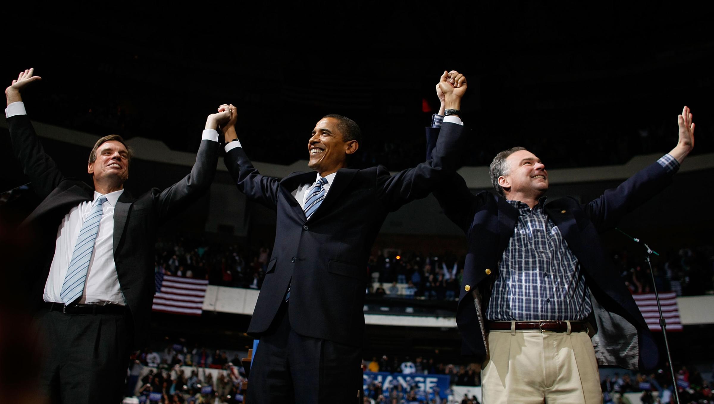 Mark Warner, Democratic presidential nominee U.S. Sen. Barack Obama and Virginia Governor Tim Kaine raise their arms together during a campaign event at the Richmond Coliseum on Oct. 22, 2008.