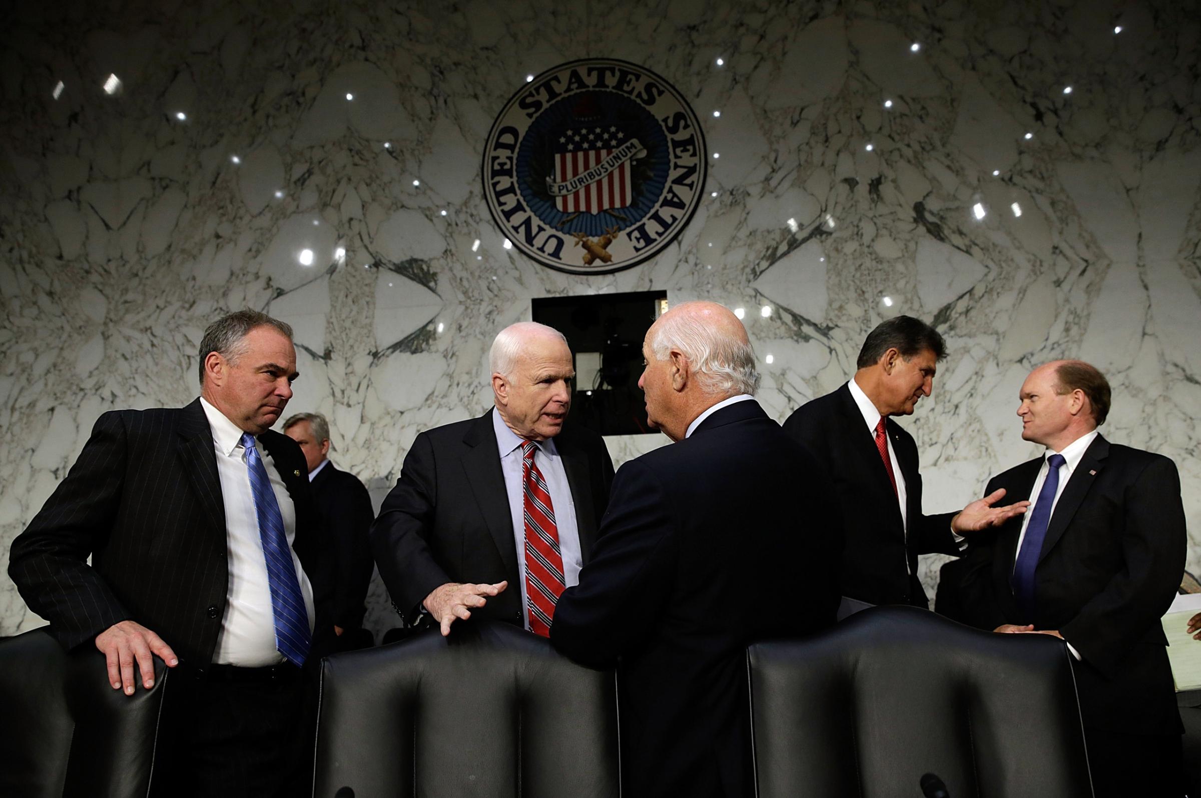U.S. Sen. Tim Kaine, Sen. John McCain, Sen. Ben Cardin, Sen. Joe Manchin and Sen. Chris Coons confer before the testimony of U.S. Secretary of State John Kerry, U.S. Defense Secretary Chuck Hagel, and U.S. Chairman of the Joint Chiefs of Staff Gen. Martin Dempsey as they appear before the Senate Foreign Relations Committee on the topic of "The Authorization of Use of Force in Syria" in Washington on Sept. 3, 2013.
