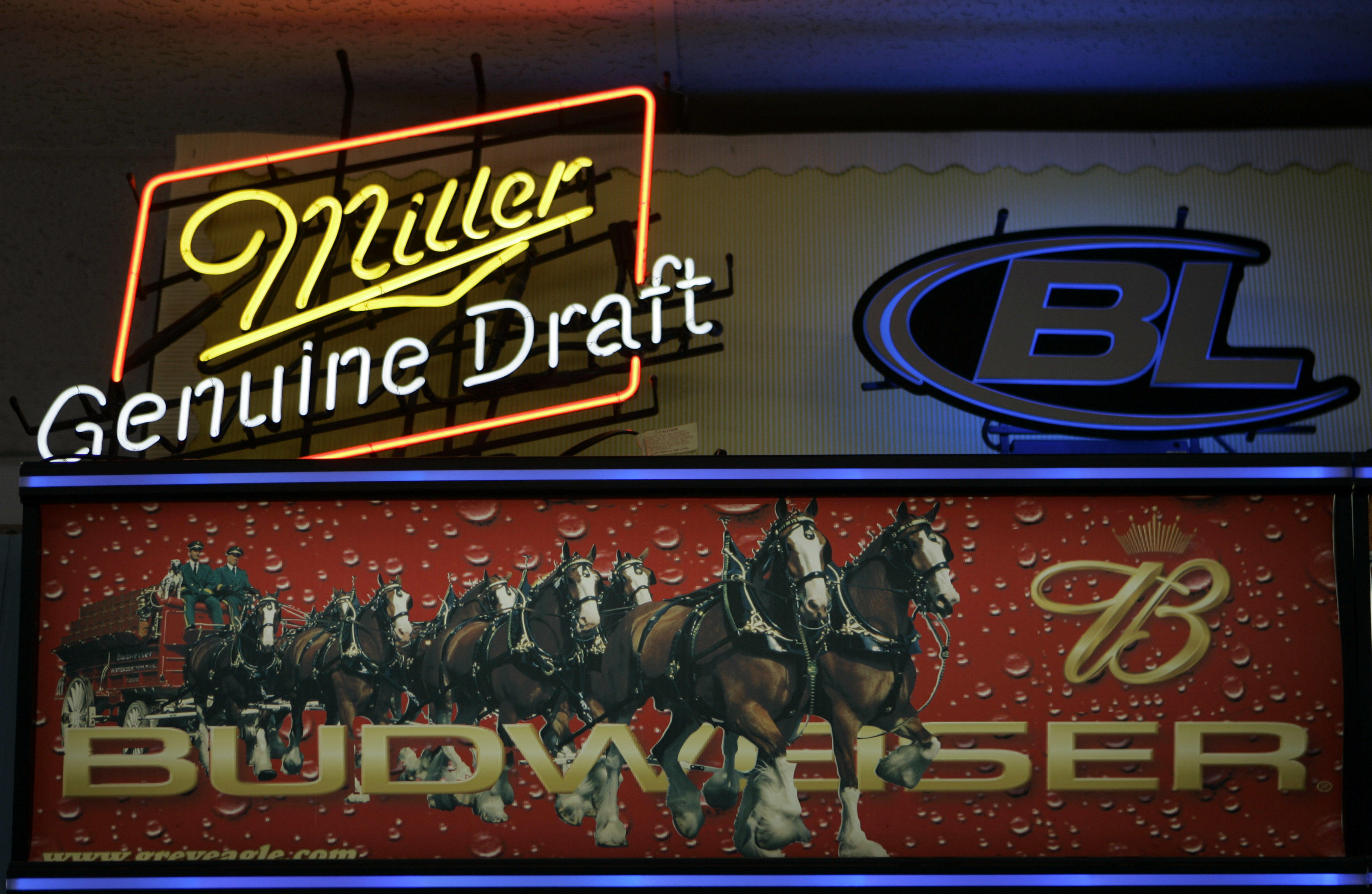 Signs for Miller and Anheuser-Busch products above a liquor store cooler in St. Louis. (Jeff Roberson—AP)