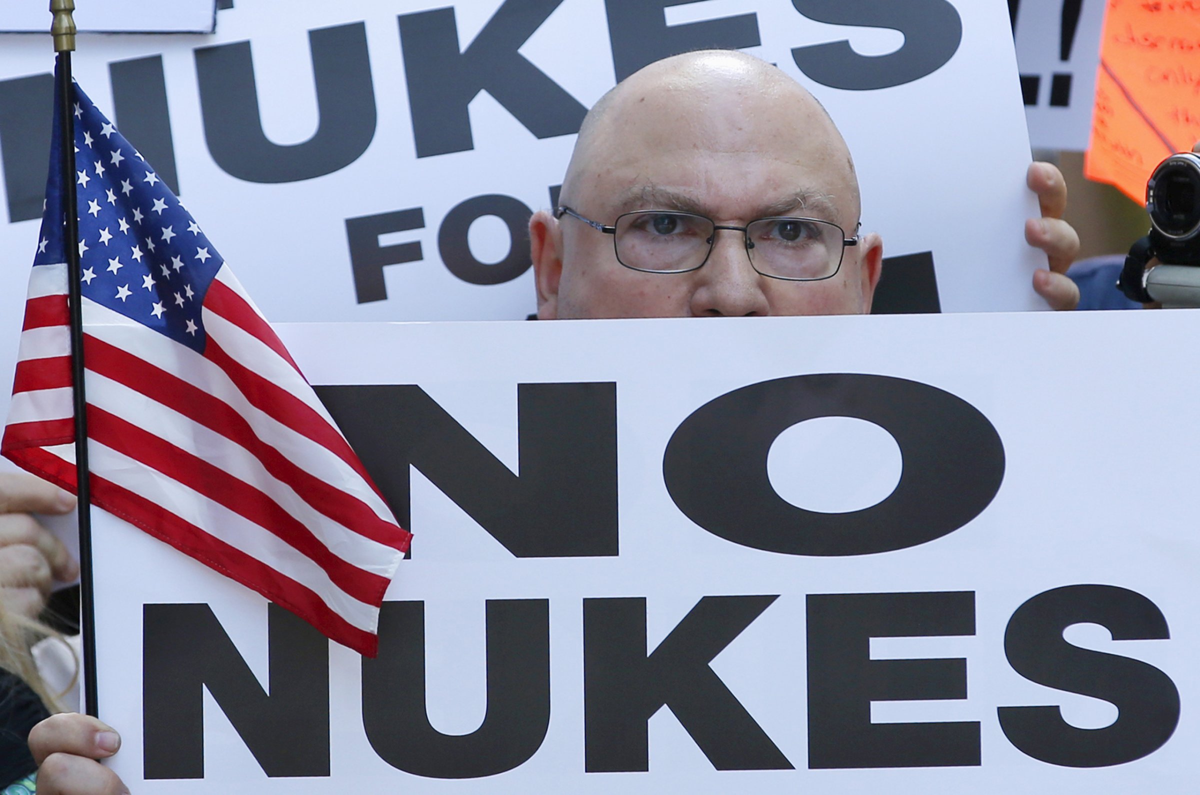 A man holds up a sign as he and several thousand other protestors demonstrate during a rally apposing the nuclear deal with Iran in Times Square in the Manhattan borough of New York City on July 22, 2015.
