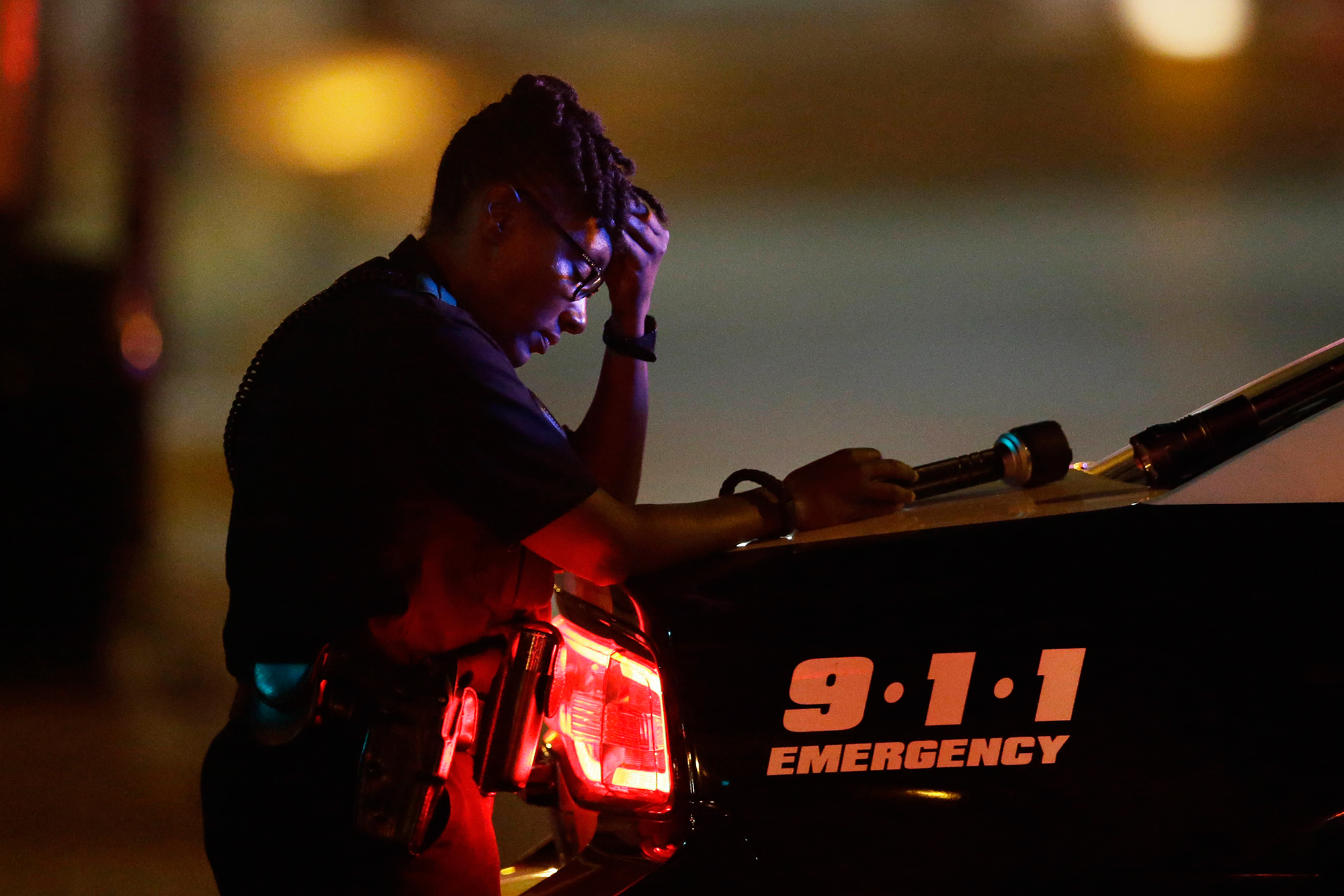 A Dallas police officer pauses for a moment in the early morning after a sniper shooting, which left five police officers dead, in Dallas, on July 8, 2016. (LM Otero—AP)