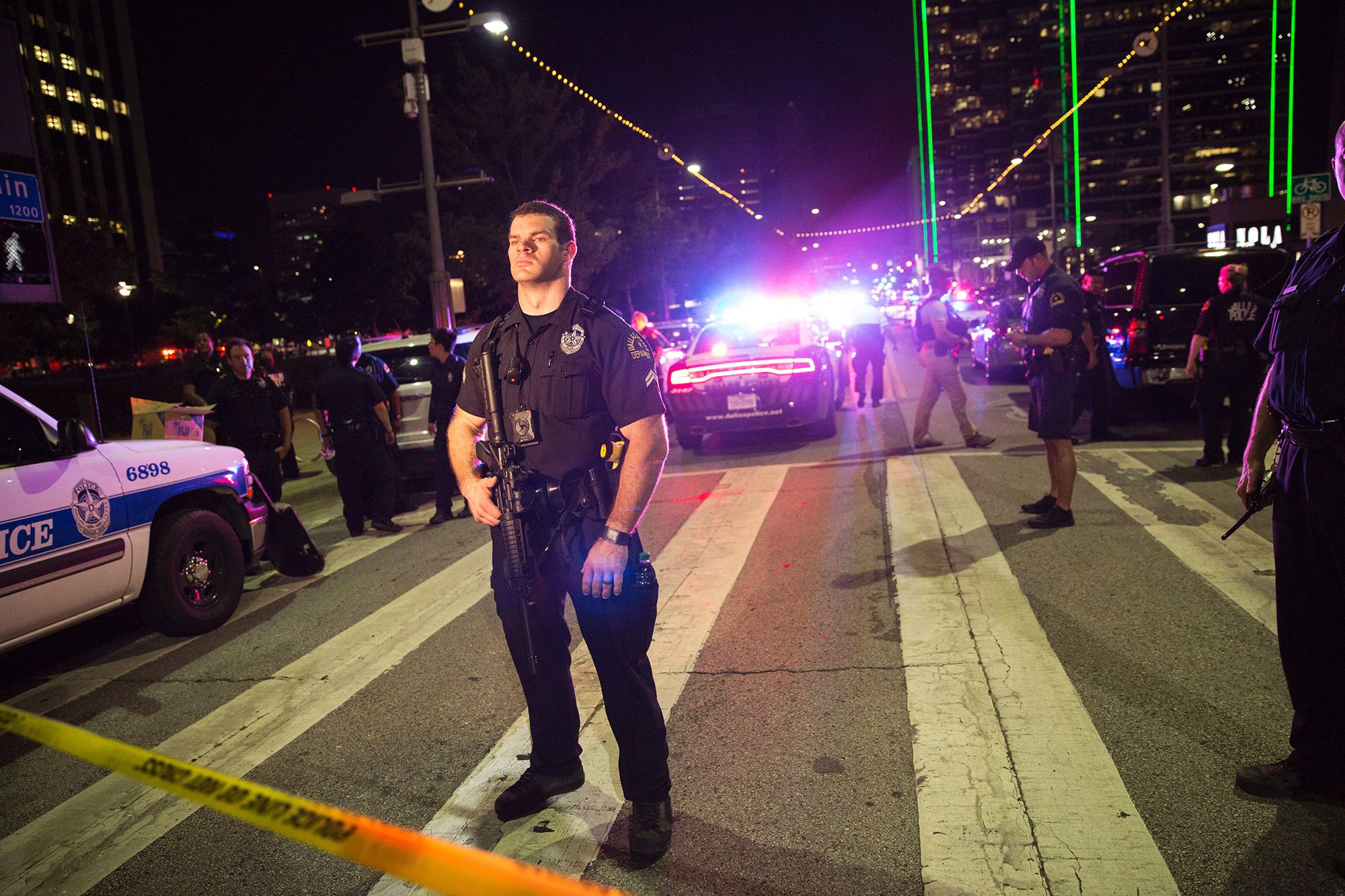 Police officers stand guard at a barricade following a sniper shooting in Dallas, on July 7, 2016.