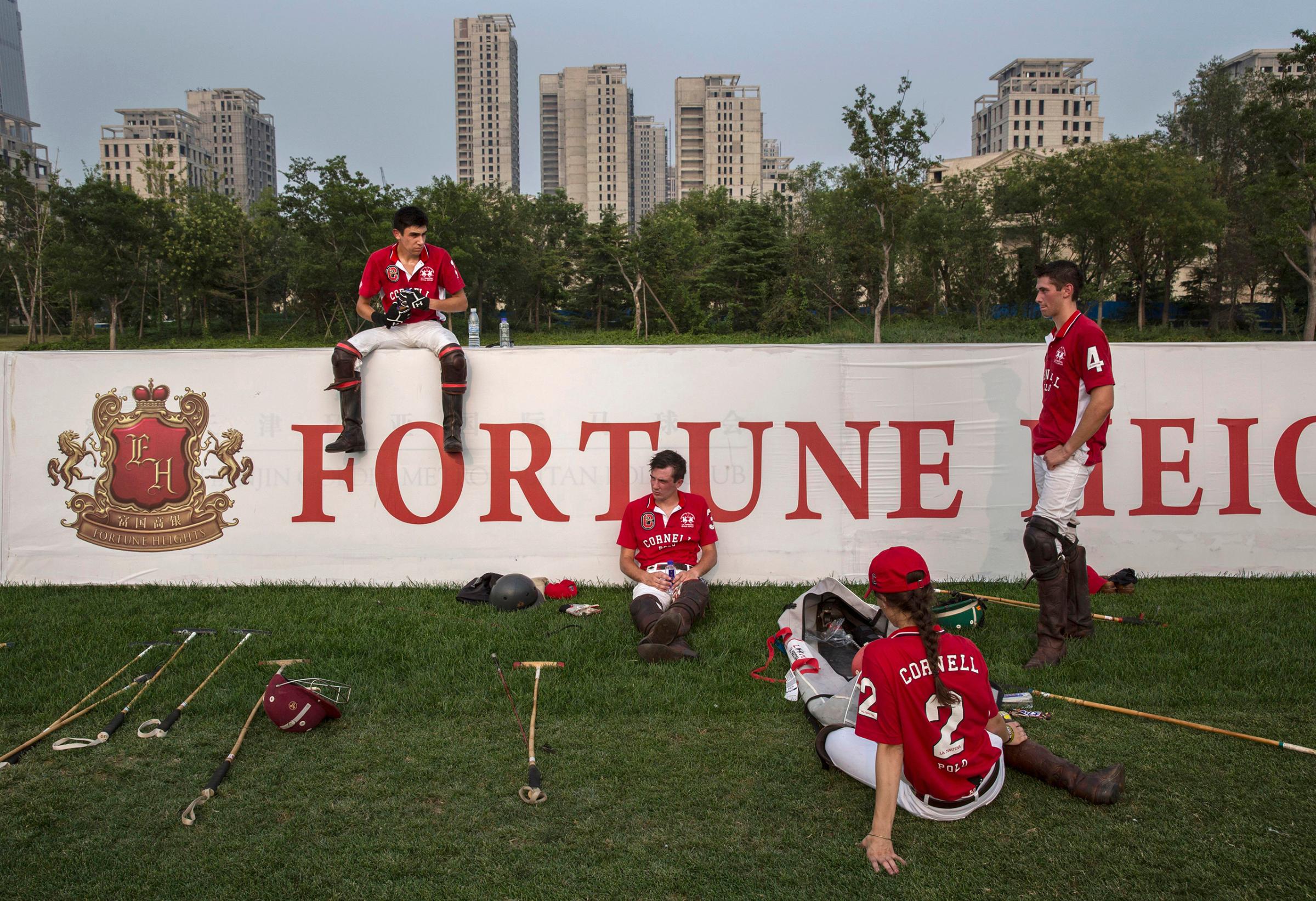 Players from the Cornell University polo team rest during a break in a match during the intervarsity tournament held at the Tianjin Goldin Metropolitan Polo Club in Tianjin, China, on July 17, 2016.