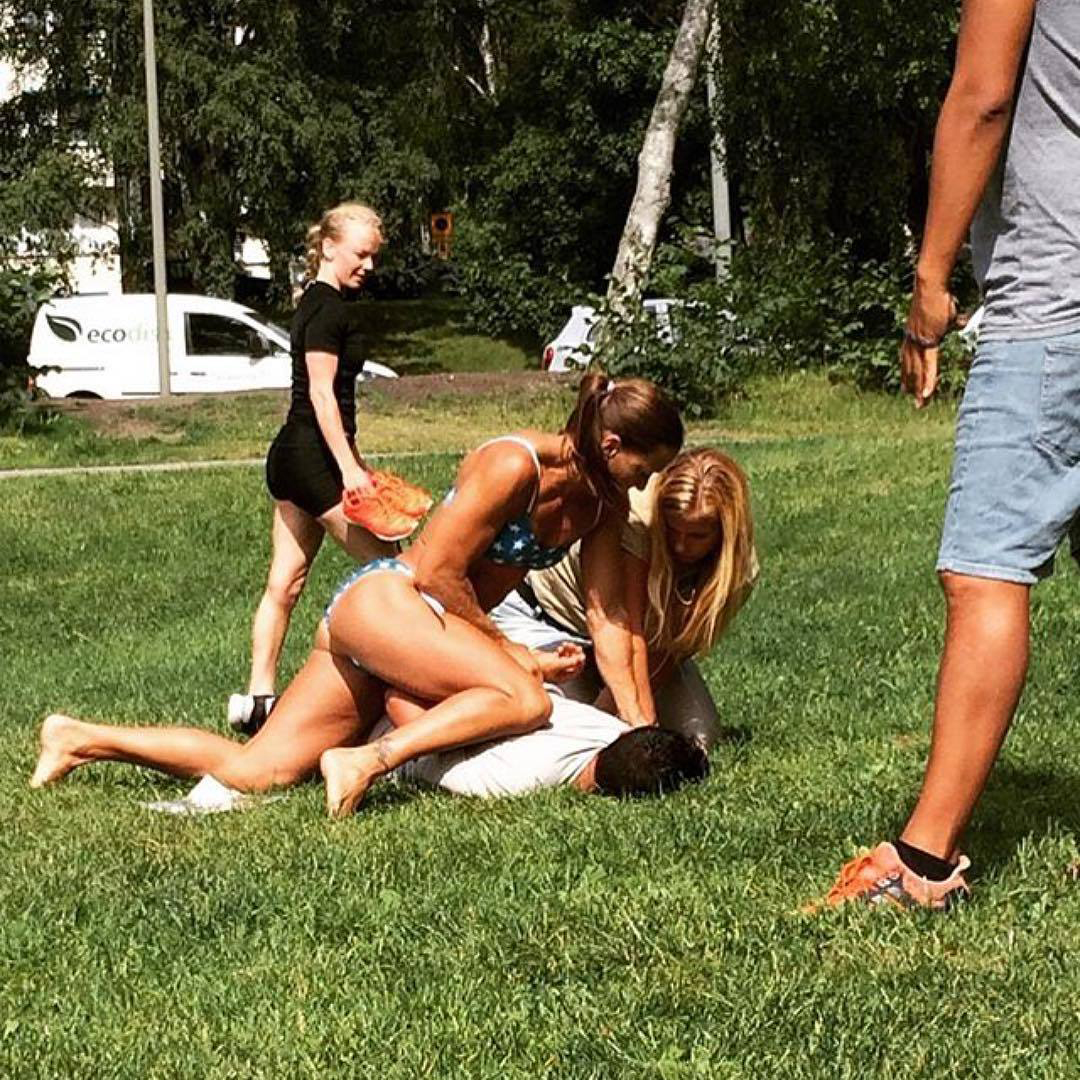 In this photo provided by Jenny Kitsune Adolffson, off-duty police officer Mikaela Kellner pins a man to the ground who was suspected to have stolen a friend's mobile phone, in Stockholm on July 27, 2016.