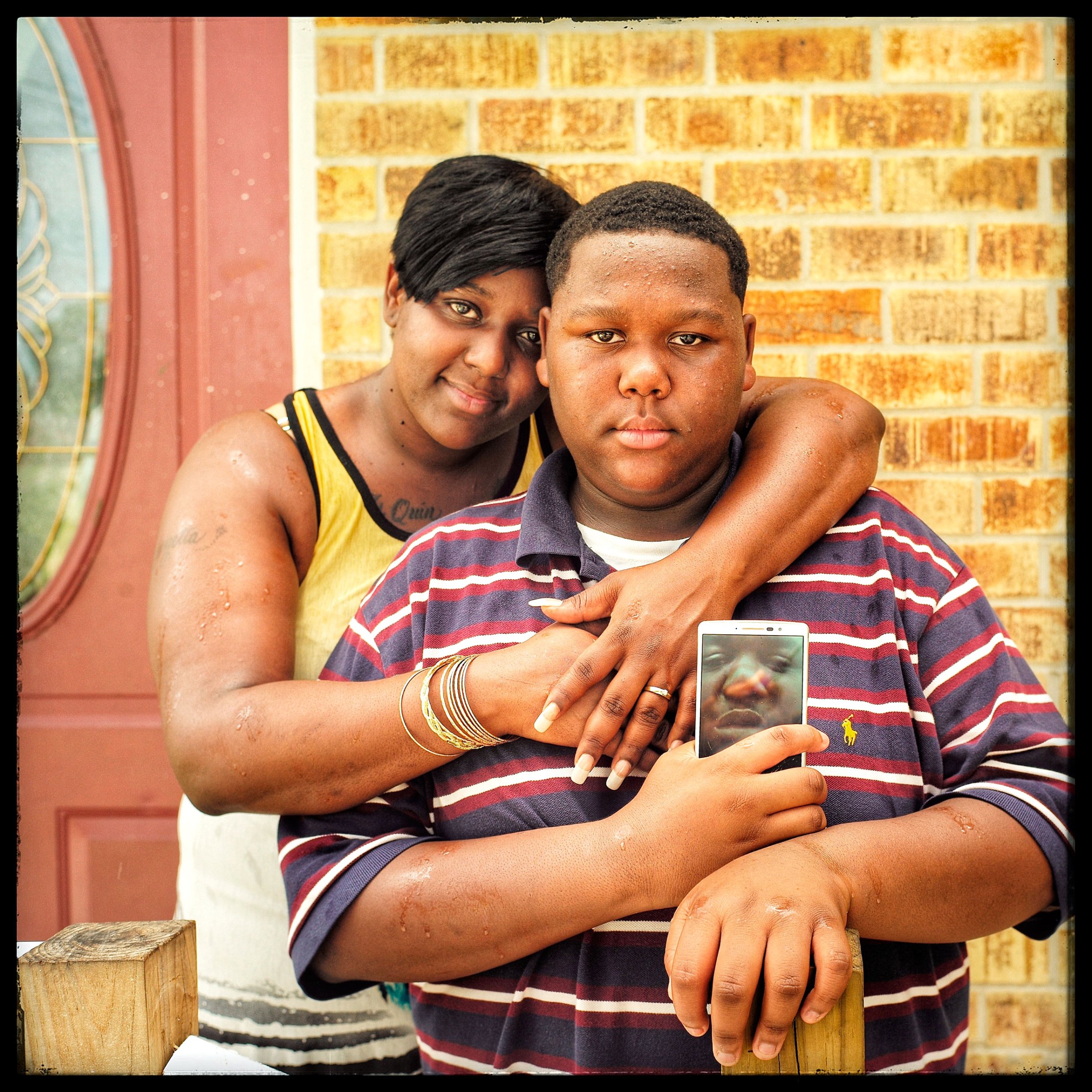 Cameron Sterling and his mother Quinyetta, in Baton Rouge, La., on July 12. Cameron, 15, holds a composite image he made of himself and his father Alton, who was fatally shot by police on July 5. “The police took his phone, so all the pictures he took are gone,” Cameron says. “Today has been a peaceful day so far. There was less drama today.”