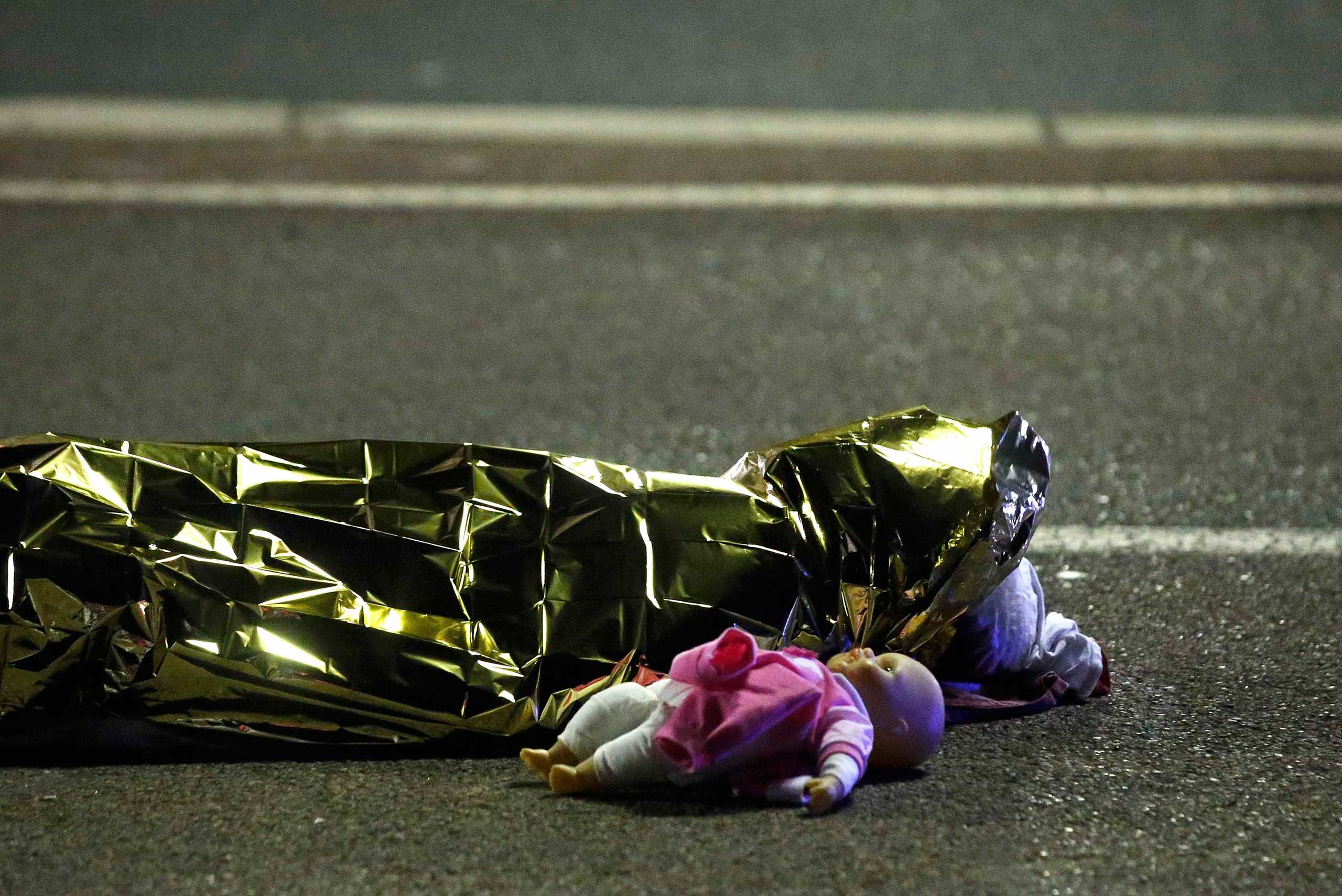 A body is seen on the ground July 15, 2016  after at least 84 people were killed in Nice, France, when a truck ran into a crowd celebrating the Bastille Day national holiday. (Eric Gaillard—Reuters)