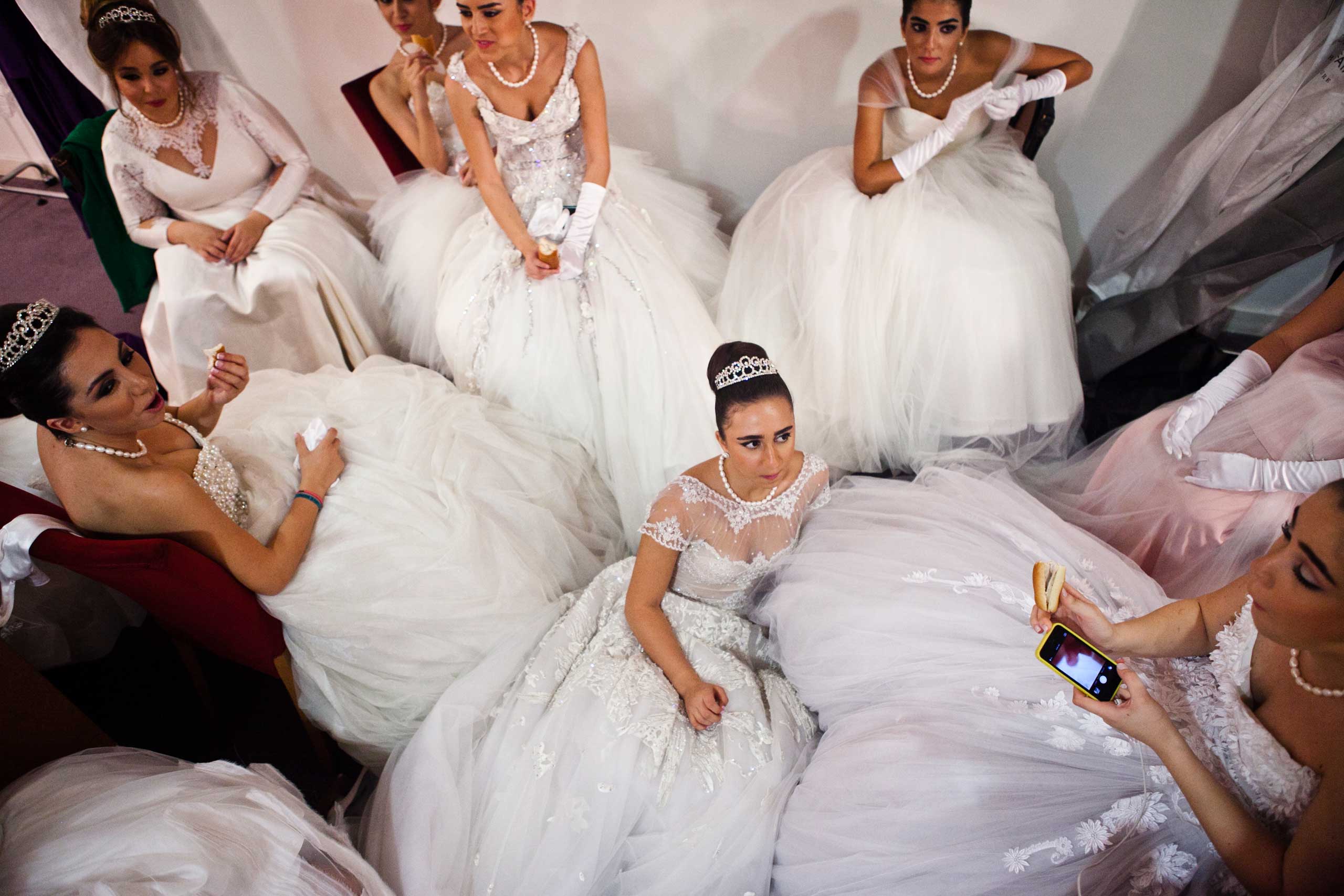 Debutante participants have a snack backstage in the dressing room before the Ball.