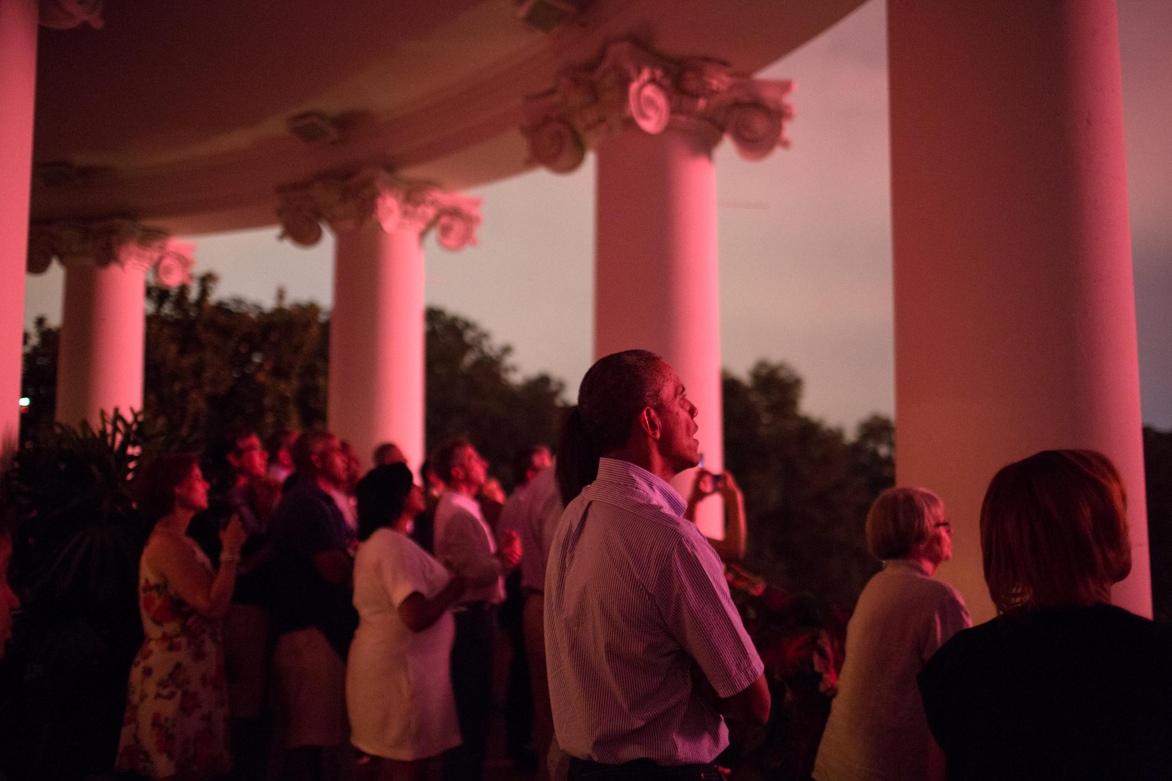 President Barack Obama, First Lady Michelle Obama, daughters Sasha and Malia, and family and friends watch the Fourth of July fireworks from the Truman Balcony of the White House, Saturday, July 4, 2015. (Official White House Photo by Pete Souza)