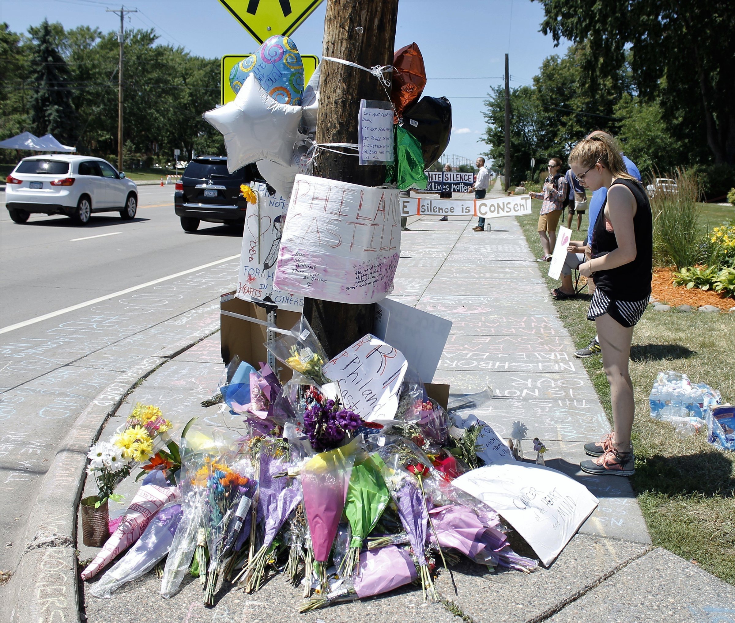 A person looks at a memorial in the Minneapolis suburb of Falcon Heights near the spot where Philando Castile was shot and killed by a police officer, July 9, 2016,.