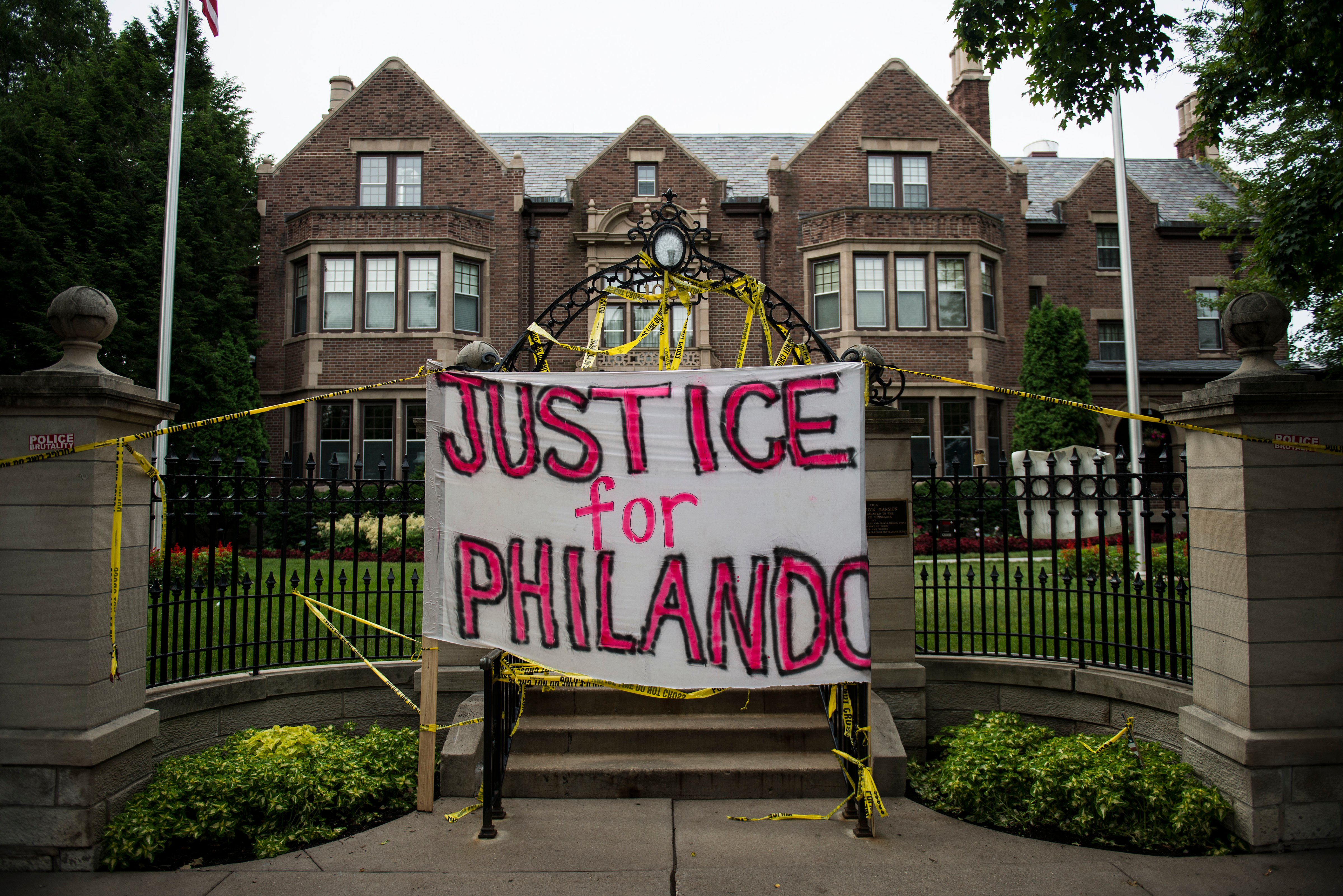 A sign reading, "Justice for Philando," and police tape are draped over the entrance of the Governor's Mansion following the police shooting death of a black man on July 7, 2016 in St. Paul, Minnesota. (Stephen Maturen/Getty Images)